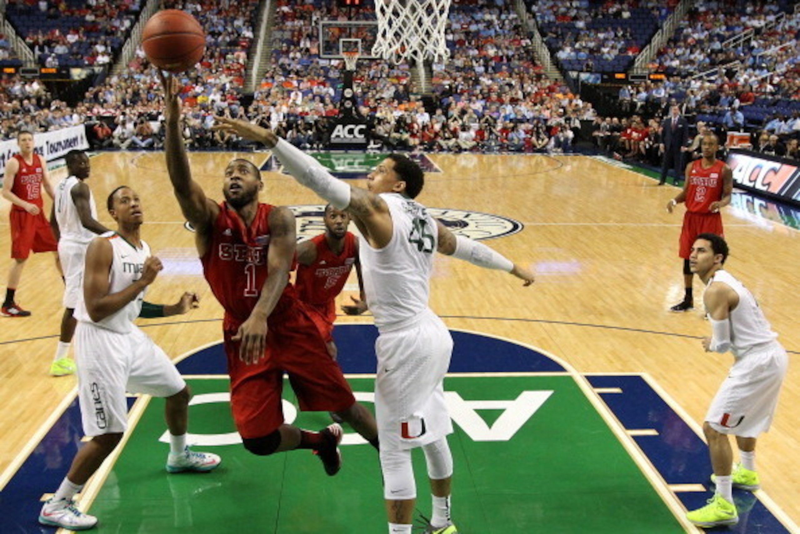 GREENSBORO, NC - MARCH 16:  Richard Howell #1 of the North Carolina State Wolfpack goes up for a shot against Julian Gamble #45 of the Miami Hurricanes during the men's ACC Tournament semifinals at Greensboro Coliseum on March 16, 2013 in Greensboro, Nort