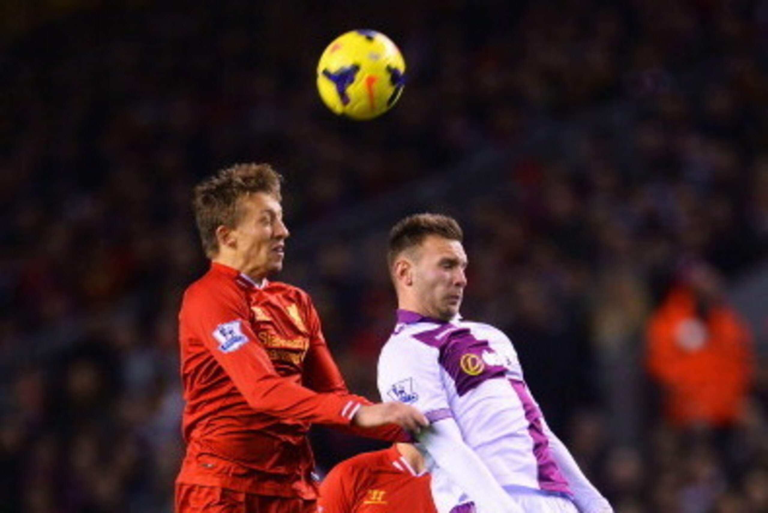 LIVERPOOL, ENGLAND - JANUARY 18: Lucas of Liverpool wins a header with Andreas Weimann of Aston Villa during the Barclays Premier League match between Liverpool and Aston Villa at Anfield on January 18, 2014 in Liverpool, England.  (Photo by Michael Regan