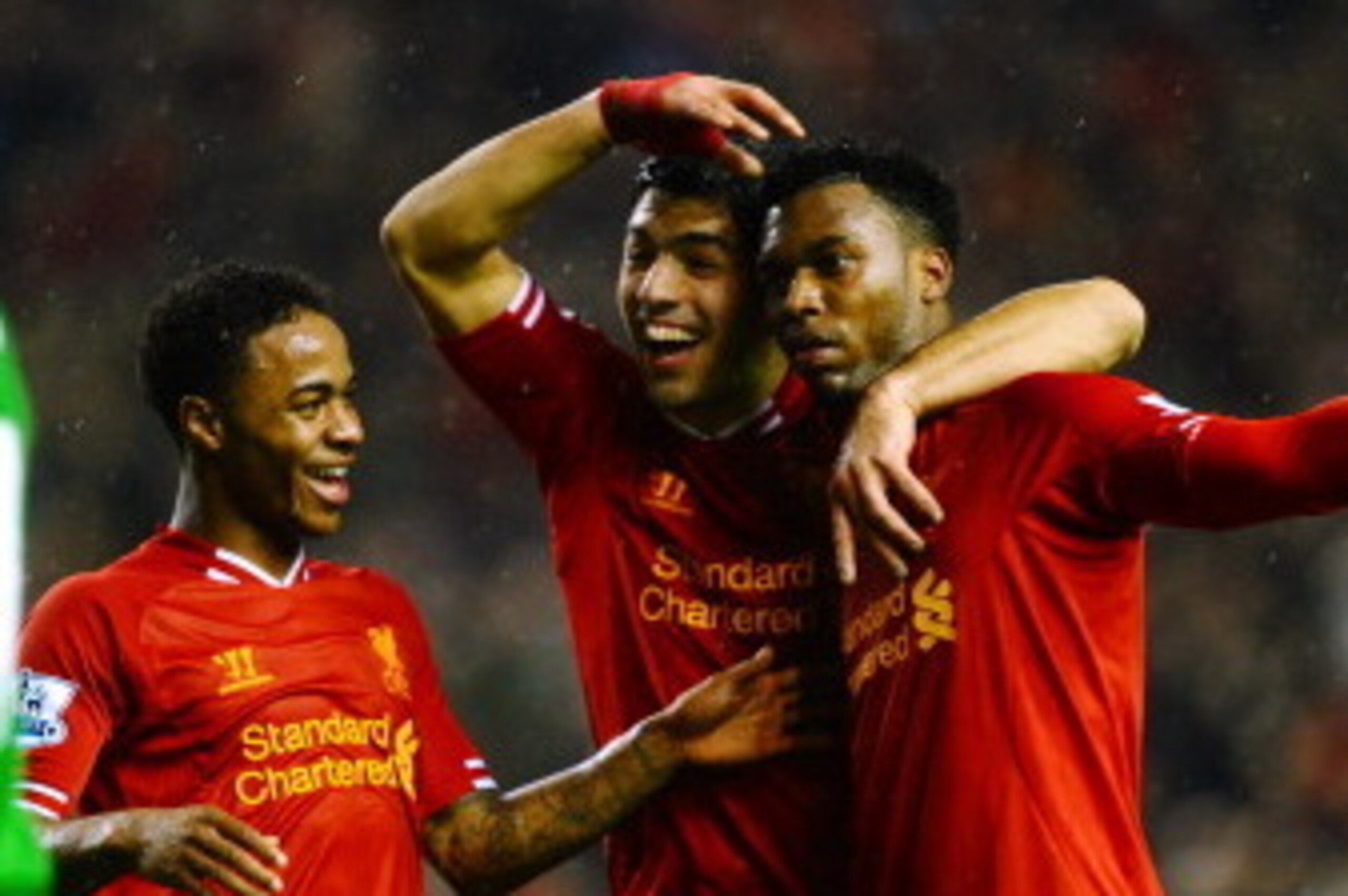 LIVERPOOL, ENGLAND - JANUARY 28:  Daniel Sturridge (R) of Liverpool is congratulated by teammates Luis Suarez (C) and Raheem Sterling (L) after scoring his team's third goal as dejected Everton goalkeeper Tim Howard looks on during the Barclays Premier Le
