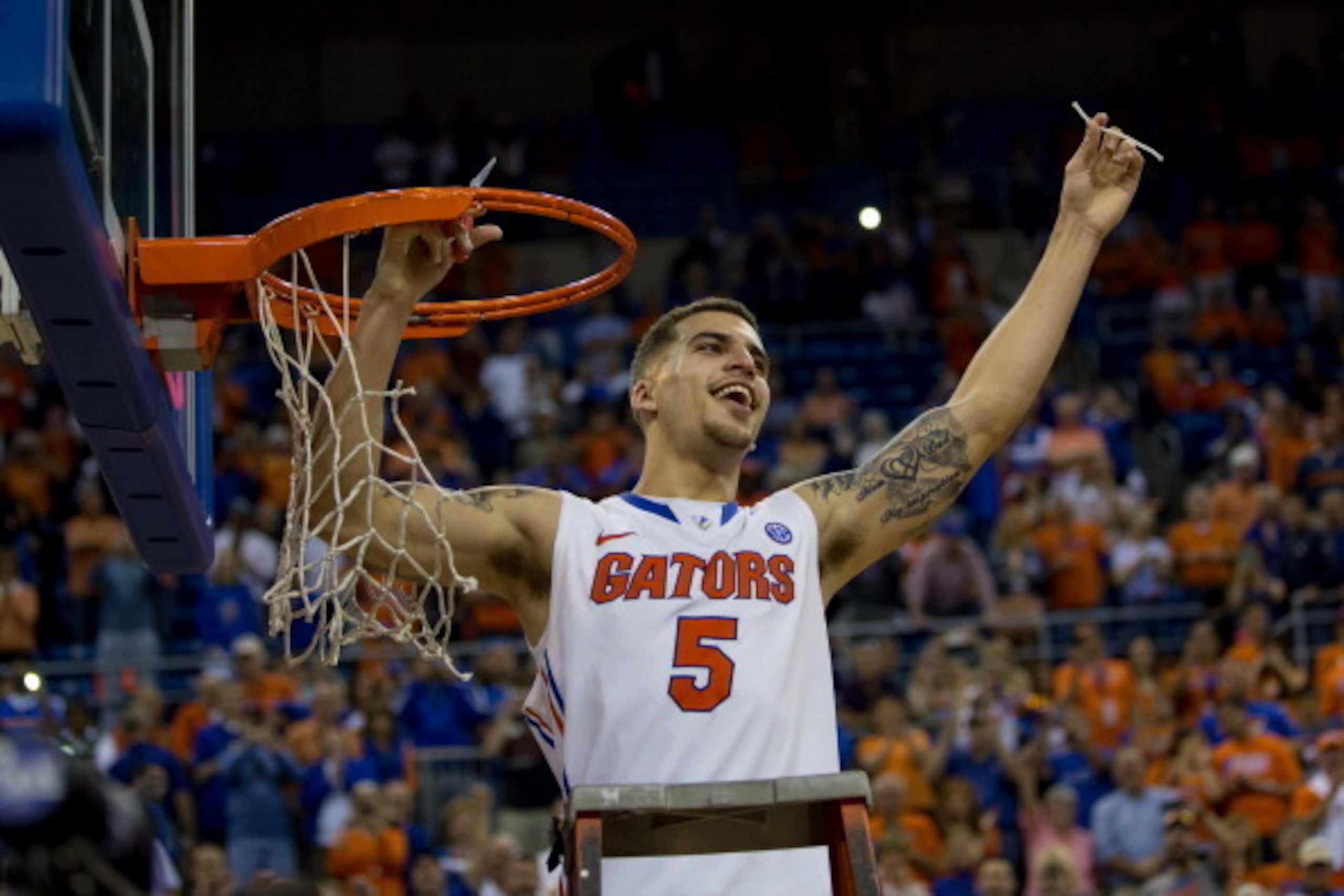 GAINESVILLE, FL - MARCH 08: Scottie Wilbekin #5 of the Florida Gators holds up a piece of the net after the game against the Kentucky Wildcats at the Stephen C. O'Connell Center on March 8, 2014 in Gainesville, Florida. The Gators were 18-0 in the SEC Con
