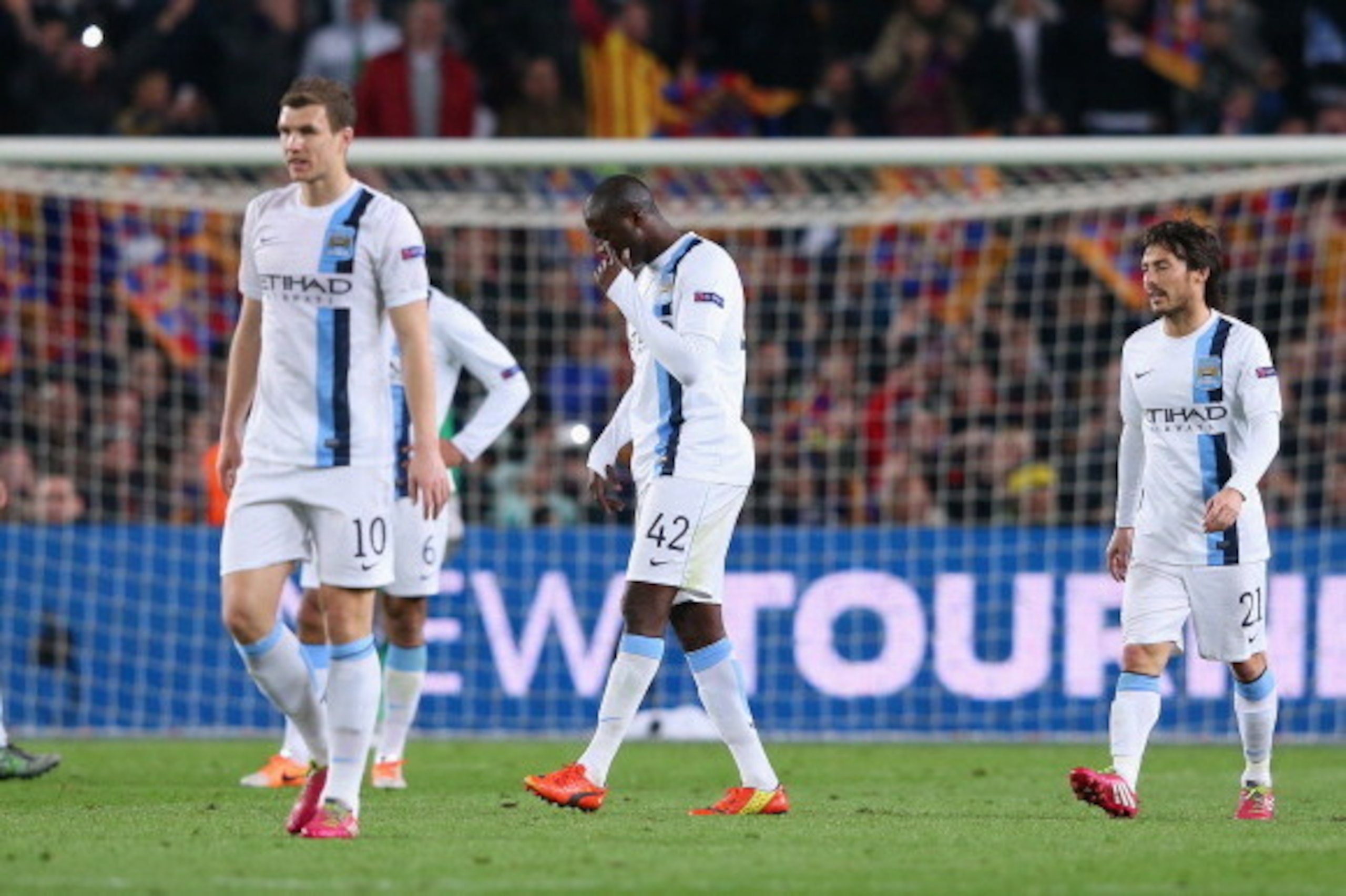 BARCELONA, SPAIN - MARCH 12:  Yaya Toure of Manchester City and team mates look dejected after conceding the opening goal during the UEFA Champions League Round of 16 match between FC Barcelona and Manchester City at Camp Nou on March 12, 2014 in Barcelon