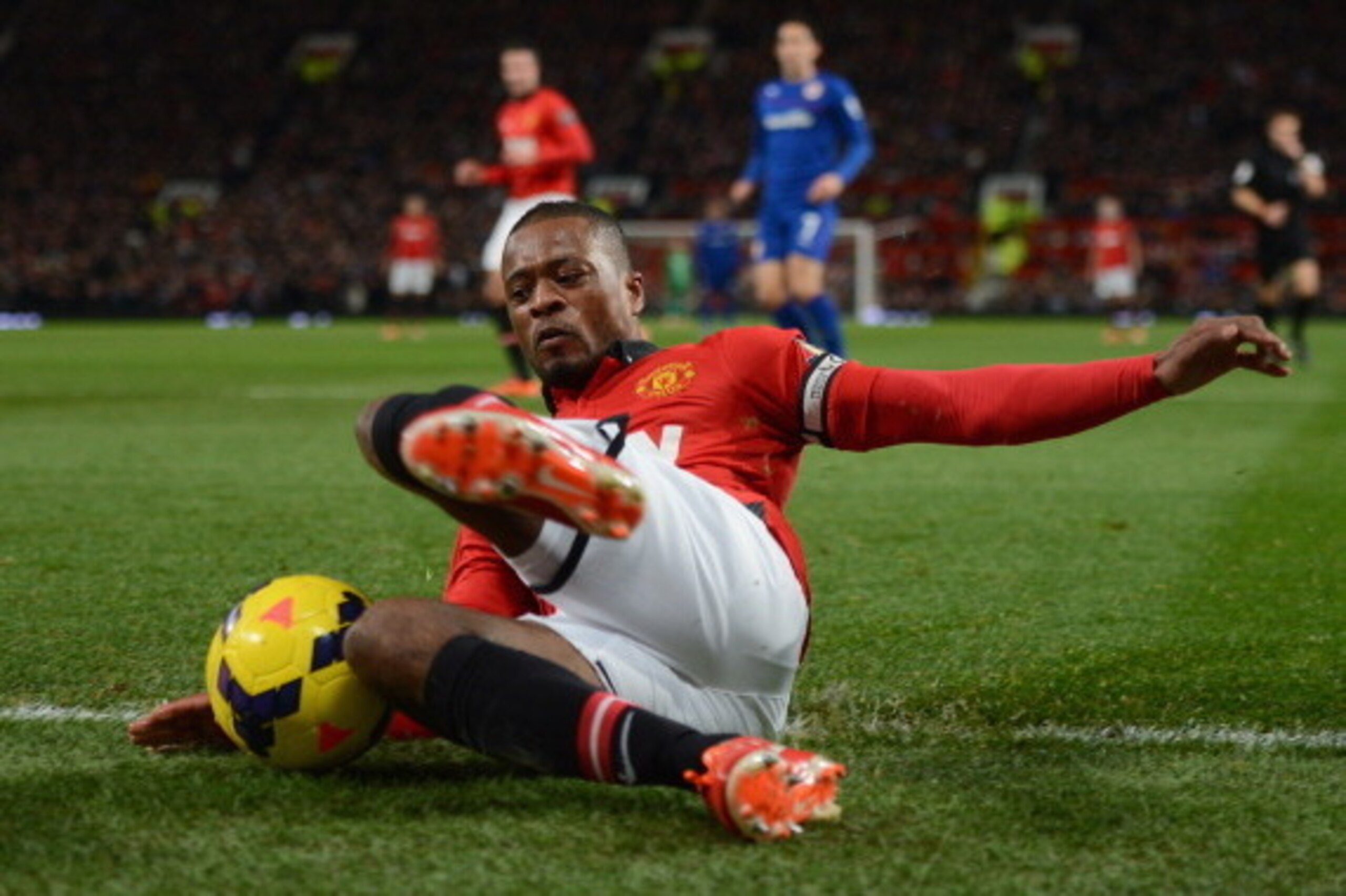MANCHESTER, ENGLAND - JANUARY 28:  Patrice Evra of Manchester United tries to keep the ball in play during the Barclays Premier League match between Manchester United and Cardiff City at Old Trafford on January 28, 2014 in Manchester, England.  (Photo by 