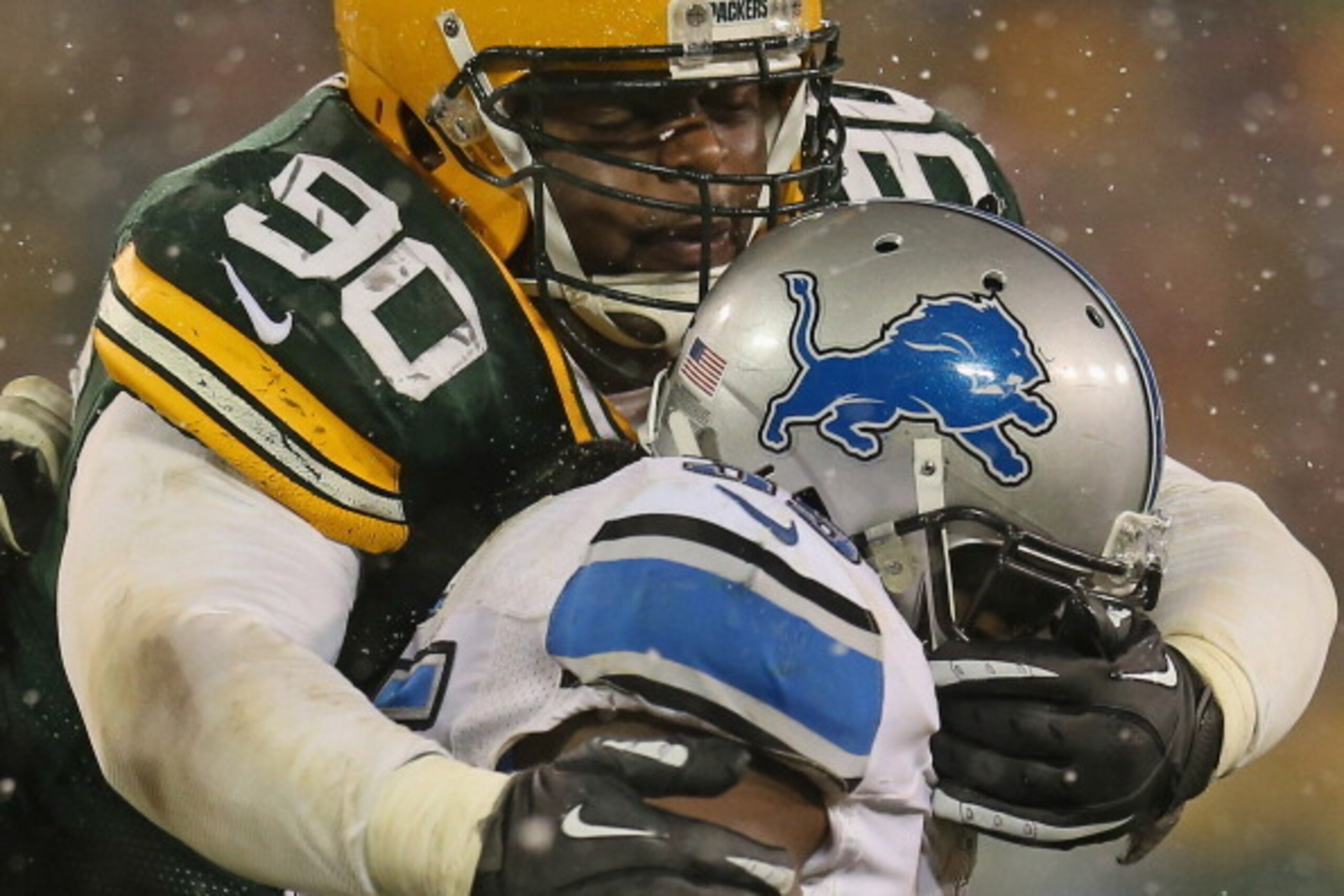 GREEN BAY, WI - DECEMBER 09: B.J. Raji #90 of the Green Bay Packers tackles Joique Bell #35 of the Detroit Lions at Lambeau Field on December 9, 2012 in Green Bay, Wisconsin. The Packers defeated the Lions 27-20. (Photo by Jonathan Daniel/Getty Images)