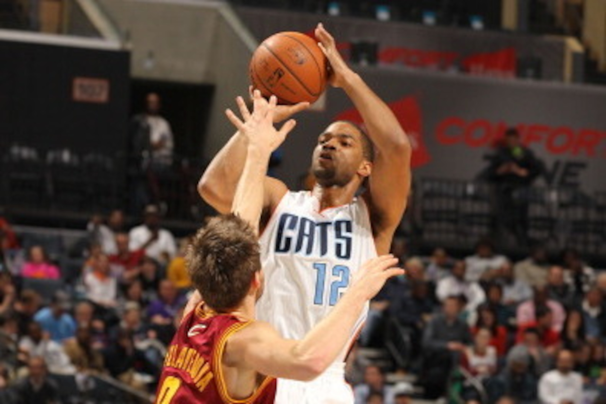 CHARLOTTE, NC - MARCH 7:  Gary Neal #12 of the Charlotte Bobcats shoots against Matthew Dellavedova #8 of the Cleveland Cavaliers during the game at the Time Warner Cable Arena on March 7, 2014 in Charlotte, North Carolina. NOTE TO USER: User expressly ac