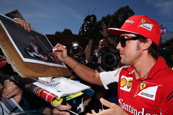 MELBOURNE, AUSTRALIA - MARCH 13:  Fernando Alonso of Spain and Ferrari signs autographs for fans during previews to the Australian Formula One Grand Prix at Albert Park on March 13, 2014 in Melbourne, Australia.  (Photo by Mark Thompson/Getty Images)