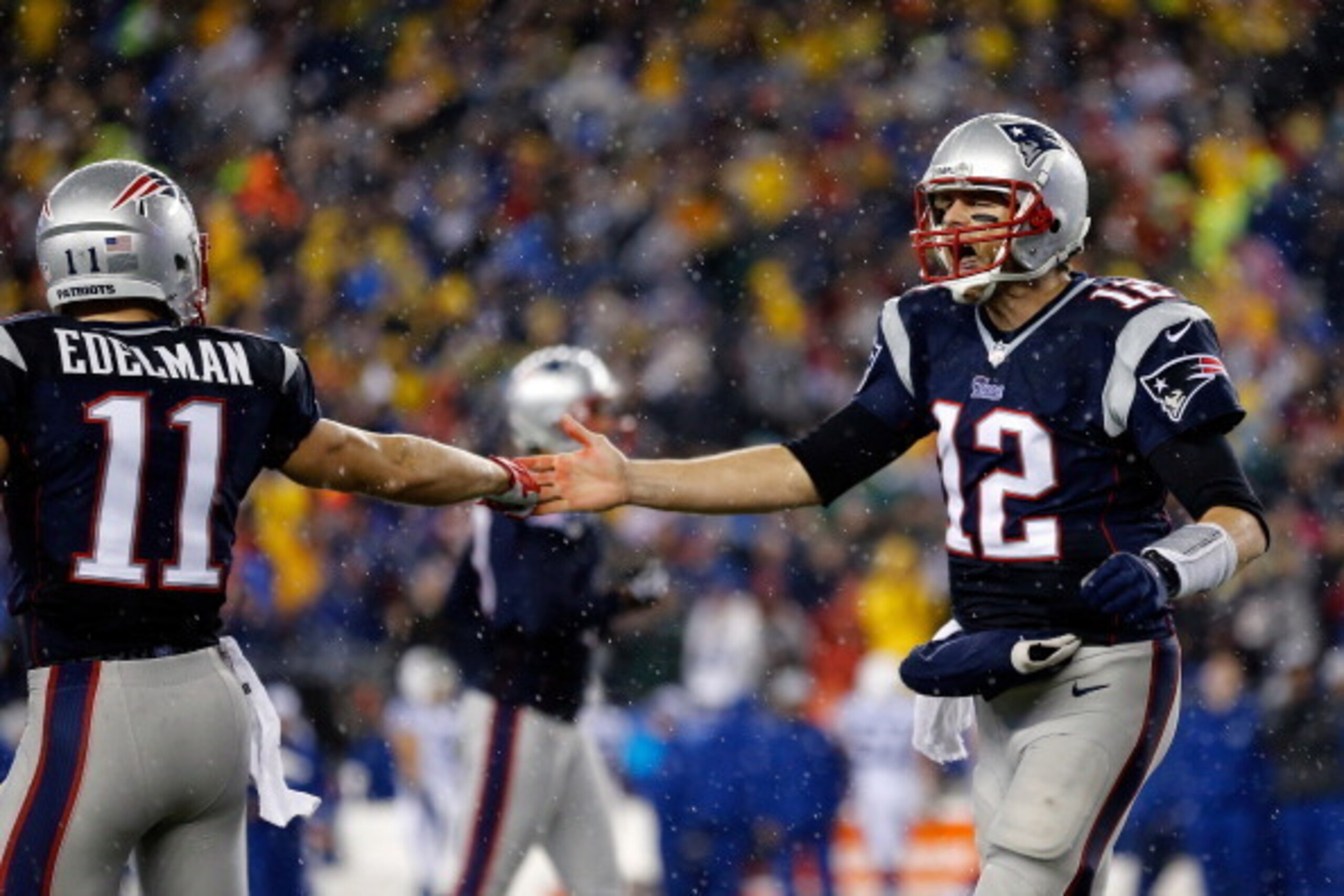 FOXBORO, MA - JANUARY 11:  Tom Brady #12 of the New England Patriots reacts with teammate  Julian Edelman #11 after a play against the Indianapolis Colts during the AFC Divisional Playoff game at Gillette Stadium on January 11, 2014 in Foxboro, Massachuse