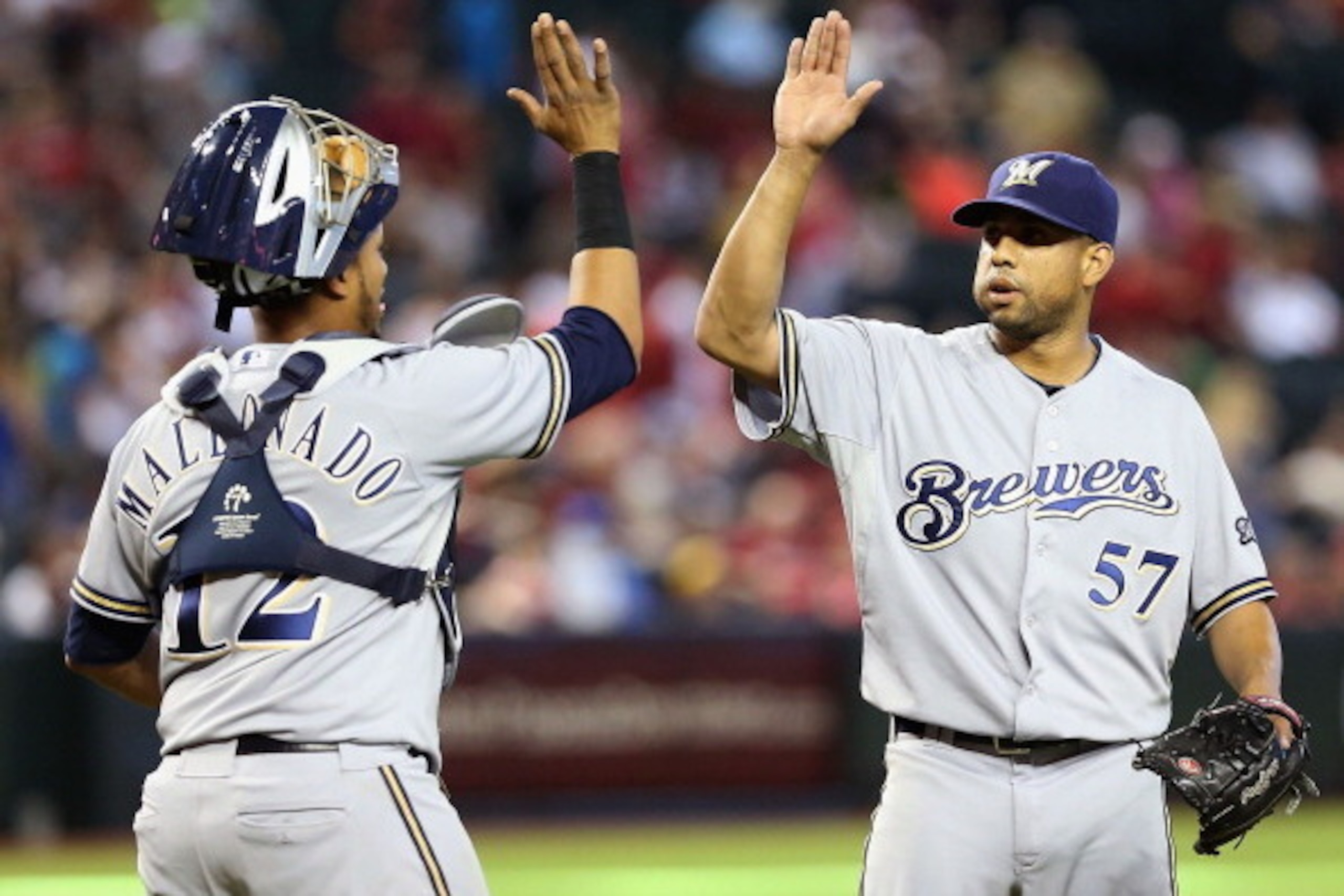 PHOENIX, AZ - JULY 14:  Relief pitcher Francisco Rodriguez #57 of the Milwaukee Brewers high fives catcher Martin Maldonado #12 after defeating the Arizona Diamondbacks in the MLB game at Chase Field on July 14, 2013 in Phoenix, Arizona. The Brewers defea