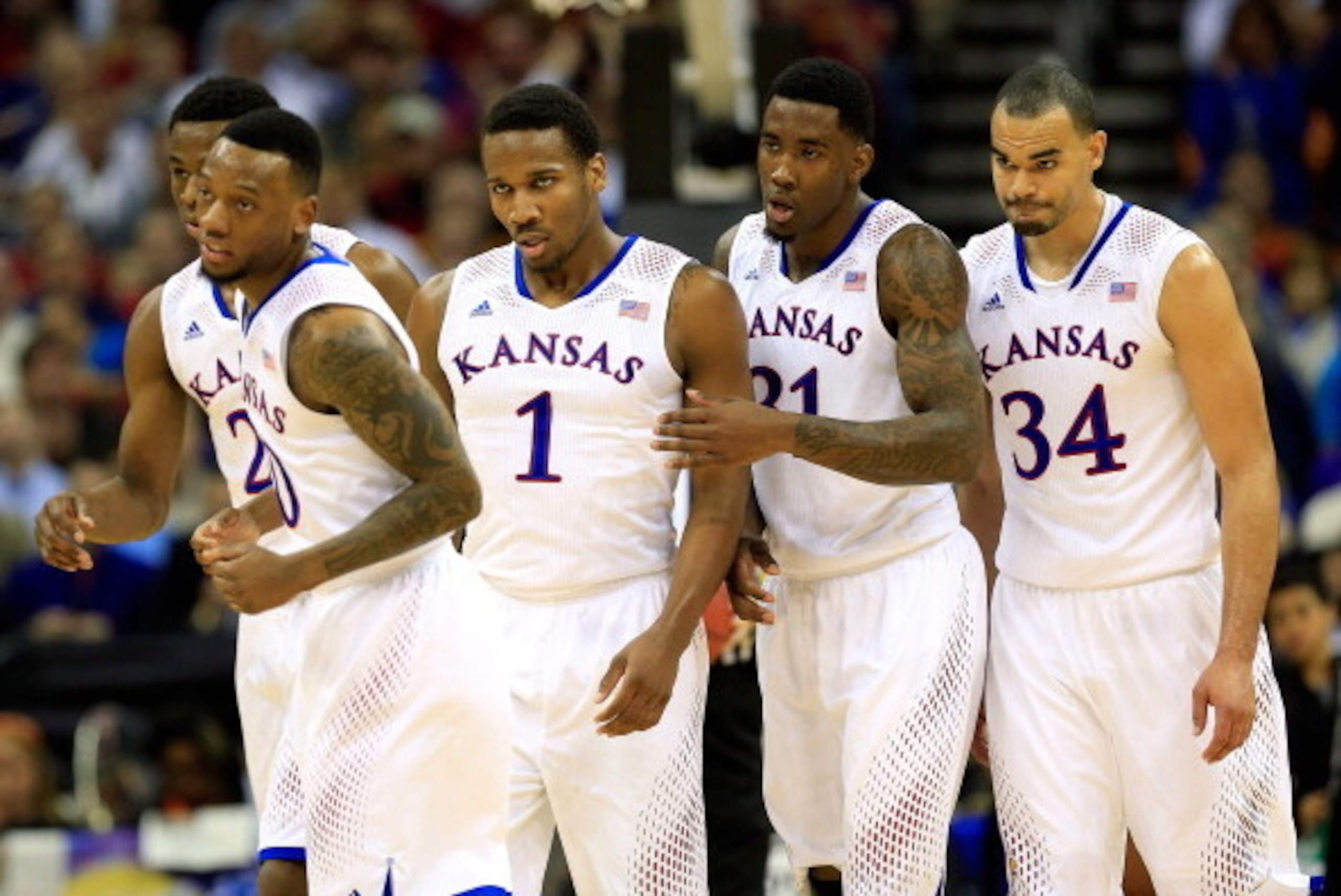 KANSAS CITY, MO - MARCH 13:  Andrew Wiggins #22, Naadir Tharpe #10, Wayne Selden, Jr. #1, Jamari Traylor #31, and Perry Ellis #34 of the Kansas Jayhawks walk toward the bench during a timeout in the Big 12 Basketball Tournament quarterfinal game against t
