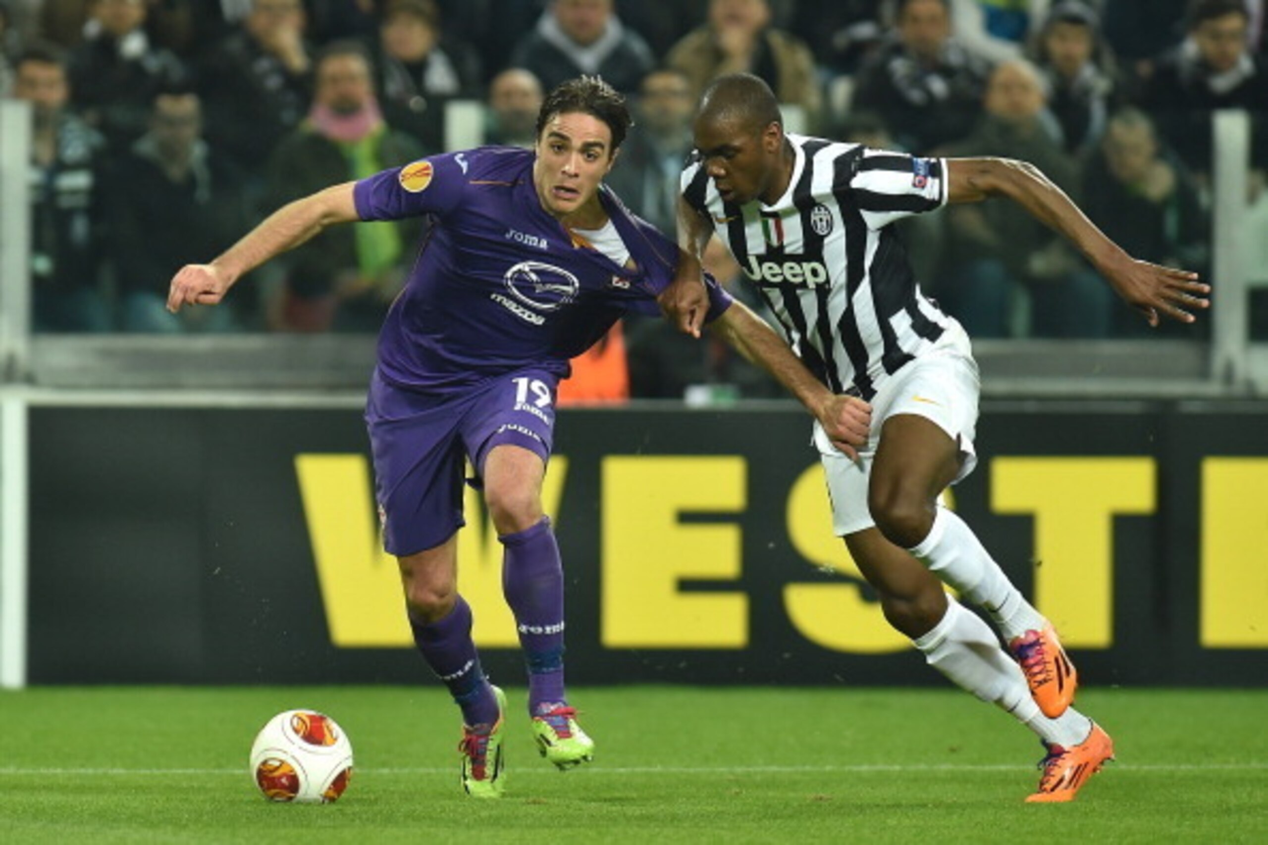 TURIN, ITALY - MARCH 13:  Alessandro Matri (L) of ACF Fiorentina is pulled by his shirt by Angelo Ogbonna of Juventus during the UEFA Europa League Round of 16 match between Juventus and ACF Fiorentina at Juventus Arena on March 13, 2014 in Turin, Italy. 
