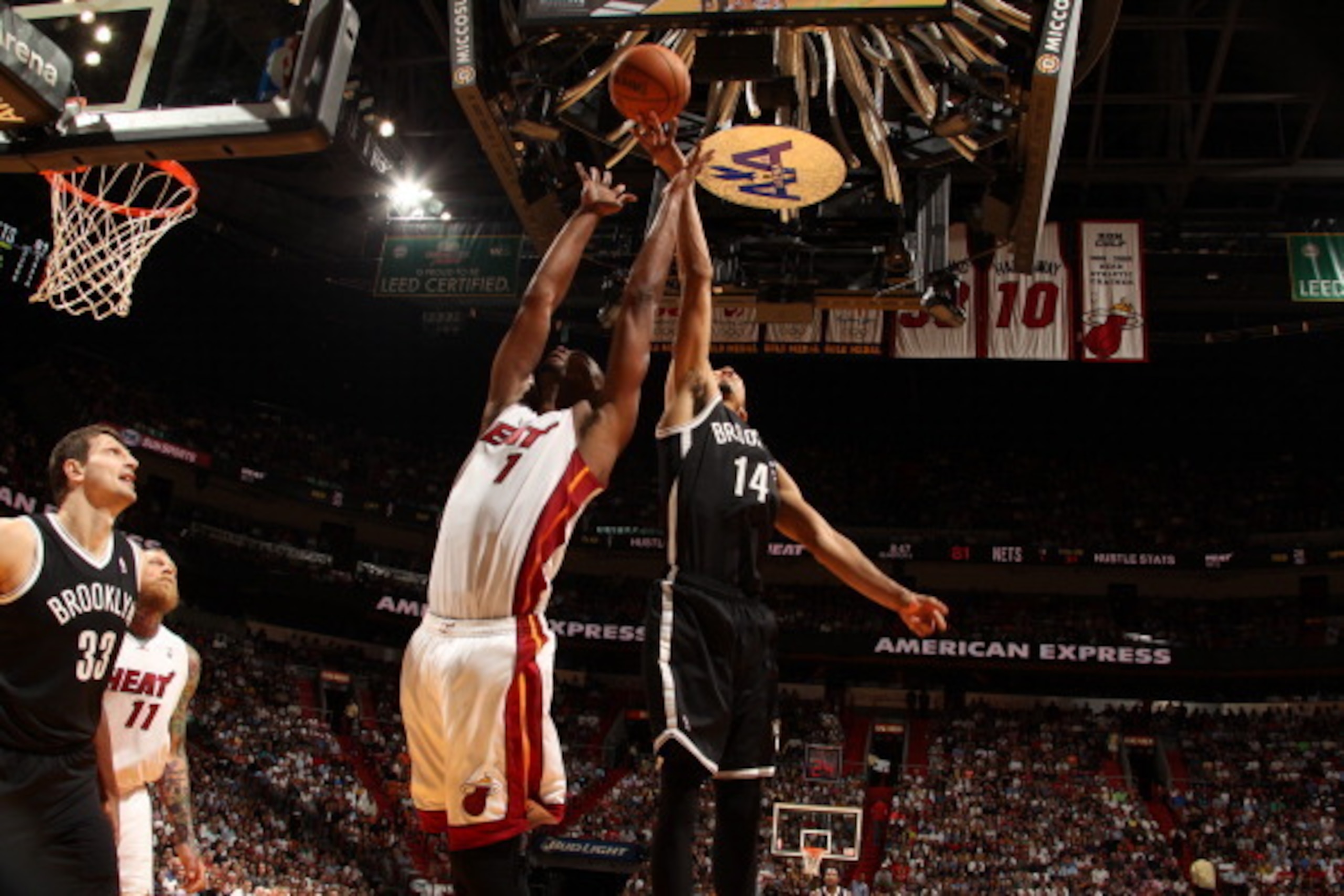 MIAMI, FL - March 12: Chris Bosh #1 of the Miami Heat and Shaun Livingston #14 of the Brooklyn Nets reach for a rebound during the game at the American Airlines Arena in Miami, Florida on March 12 2014. NOTE TO USER: User expressly acknowledges and agrees