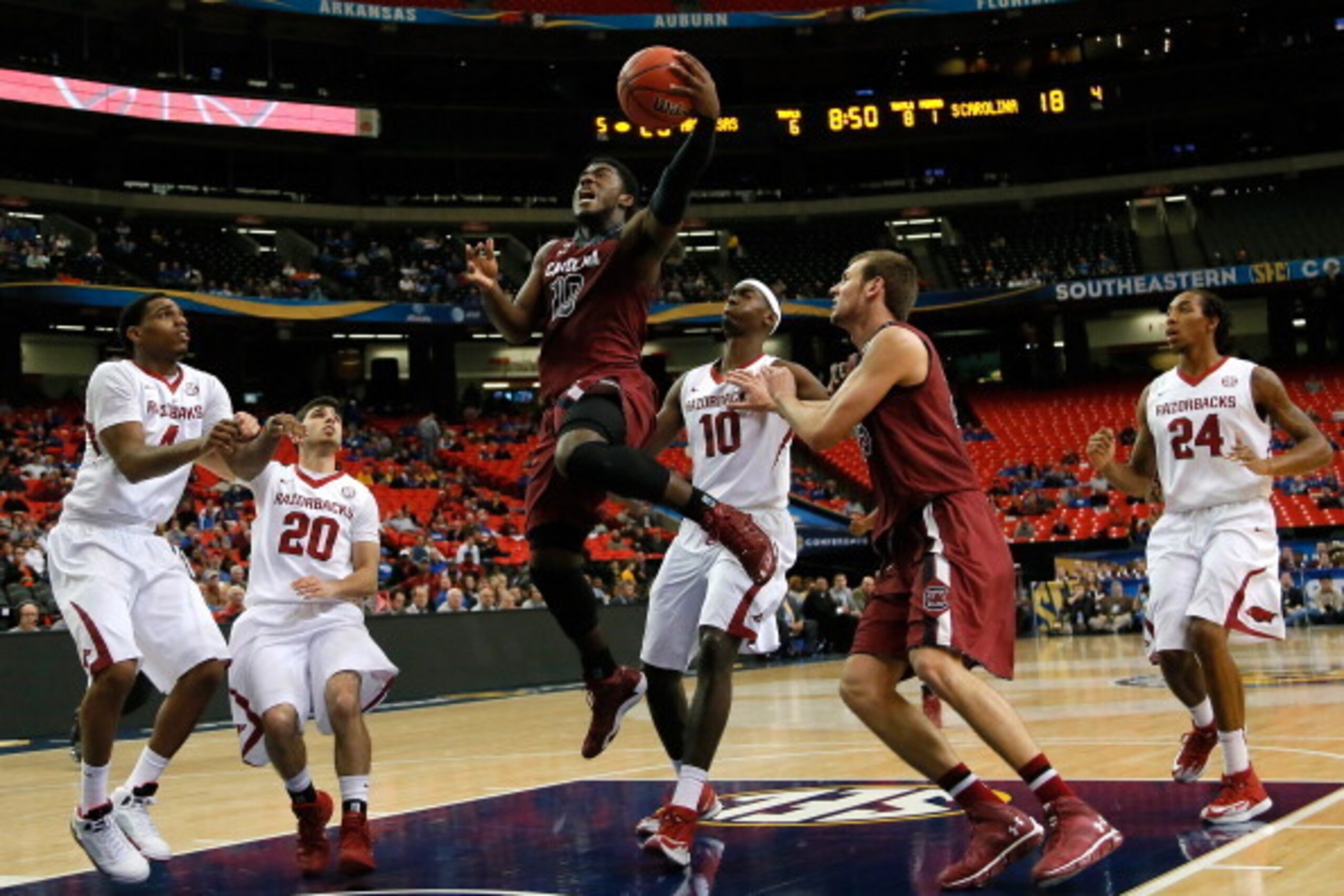 ATLANTA, GA - MARCH 13:  Duane Notice #10 of the South Carolina Gamecocks drives against Bobby Portis #10, Kikko Haydar #20 and Coty Clarke #4 of the Arkansas Razorbacks during the second round of the SEC Men's Basketball Tournament at Georgia Dome on Mar
