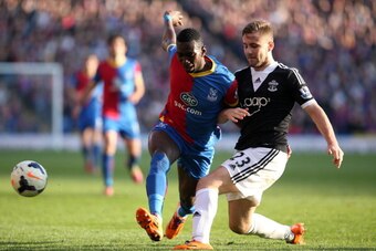 LONDON, ENGLAND - MARCH 08: Yannick Bolasie of Palace tries to get past Luke Shaw of Southampton during the Barclays Premier League match between Crystal Palace and Southampton at Selhurst Park on March 08, 2014 in London, England. (Photo by Charlie Crowh