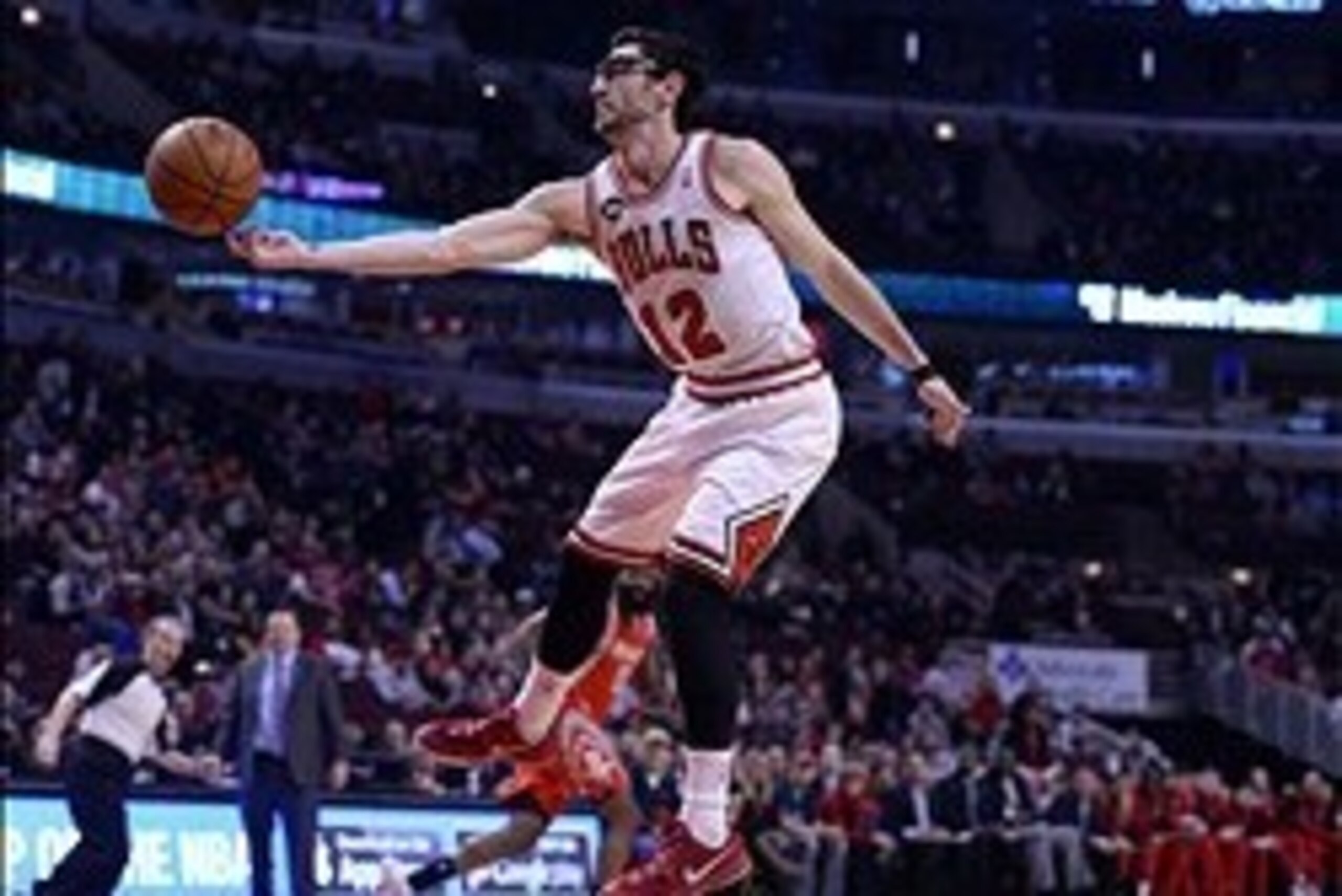 Mar 13, 2014; Chicago, IL, USA; Chicago Bulls guard Kirk Hinrich (12) grabs a rebound against the Houston Rockets during the first quarter at the United Center. Mandatory Credit: Mike DiNovo-USA TODAY Sports
