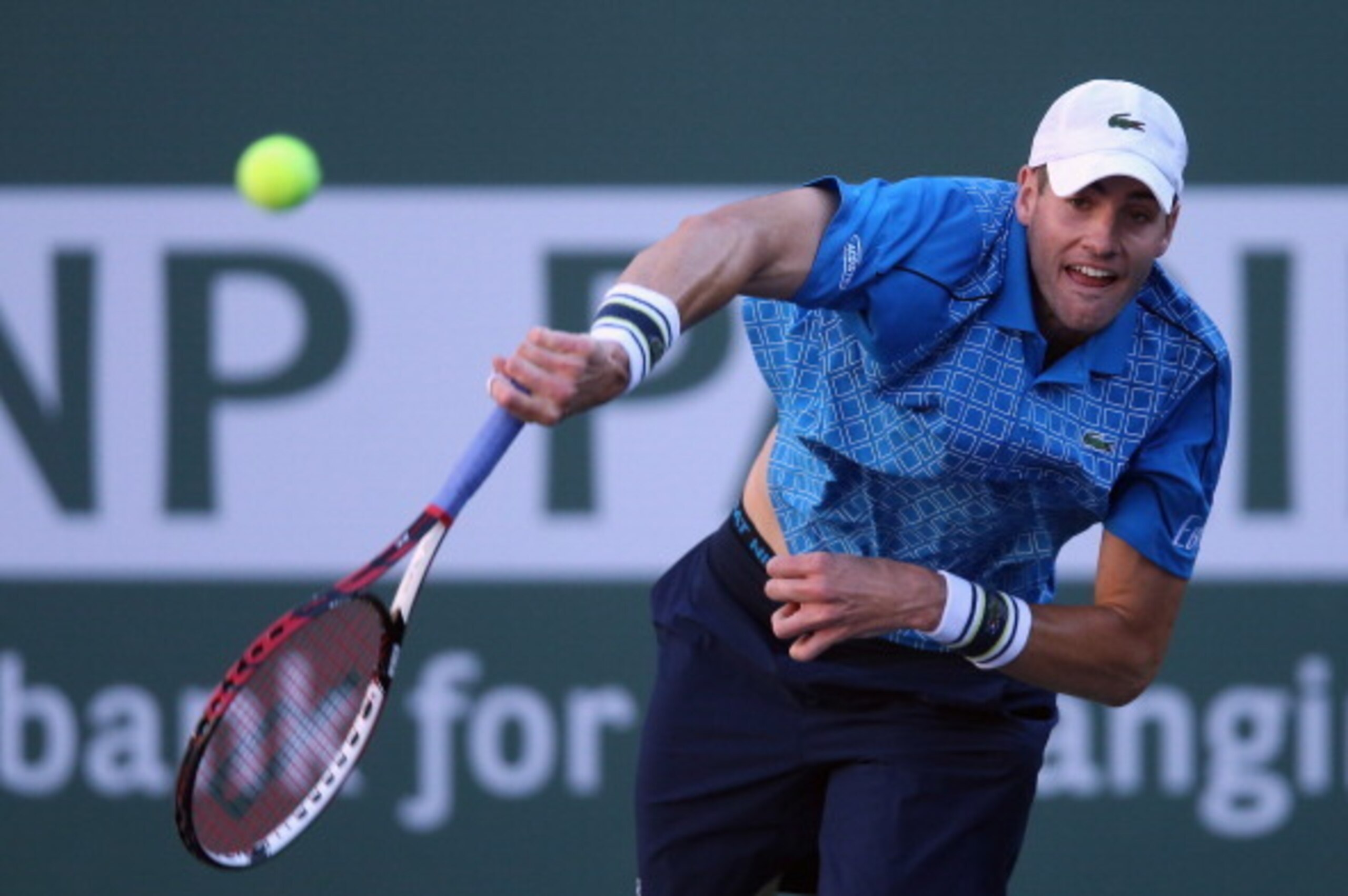 INDIAN WELLS, CA - MARCH 12:  John Isner serves to Fernando Verdasco of Spain during the BNP Paribas Open at Indian Wells Tennis Garden on March 12, 2014 in Indian Wells, California.  (Photo by Jeff Gross/Getty Images)