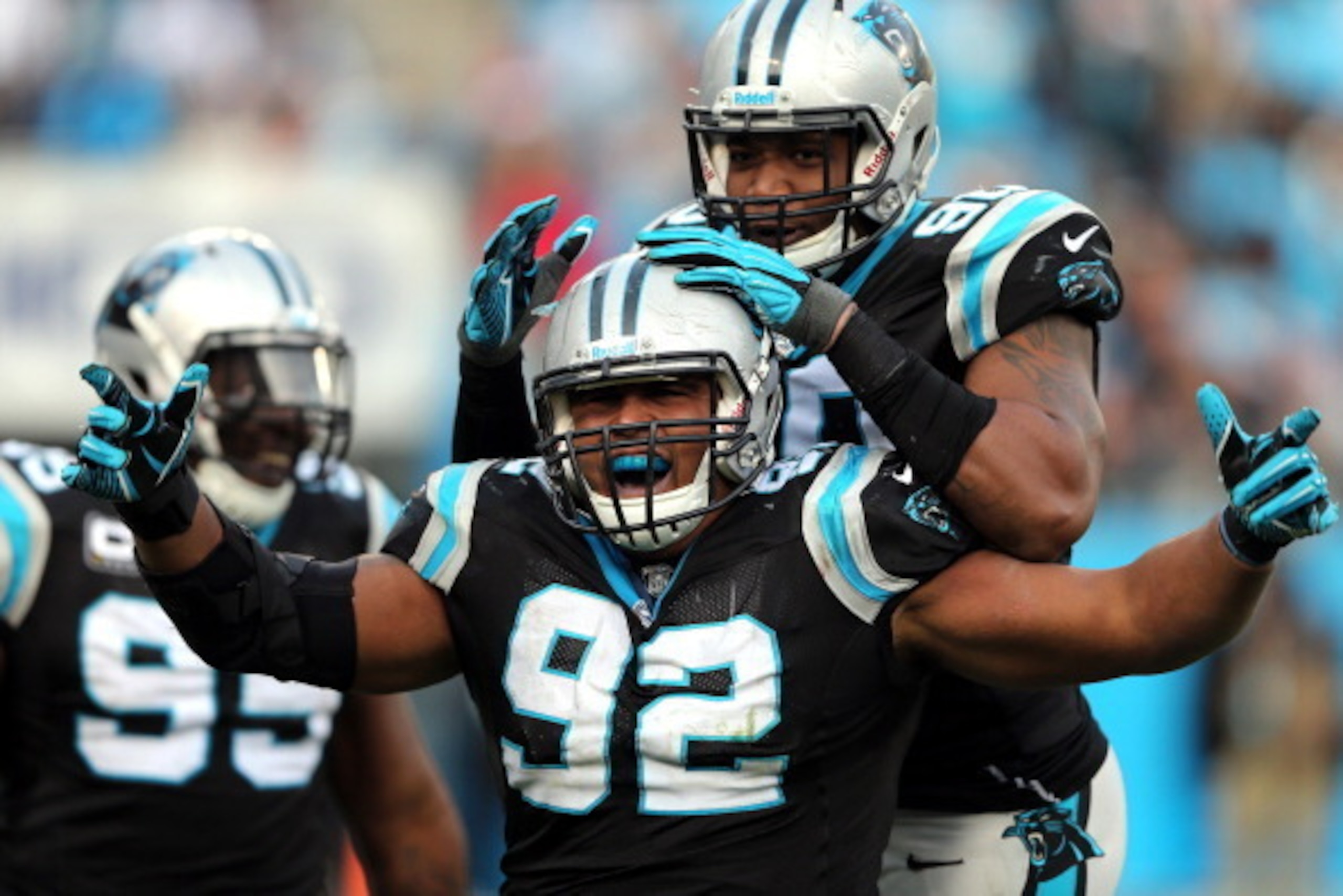 CHARLOTTE, NC - DECEMBER 23:   Dwan Edwards #92 of the Carolina Panthers celebrates after a sack with teammate  Frank Alexander #90 during their game against the Oakland Raiders at Bank of America Stadium on December 23, 2012 in Charlotte, North Carolina.