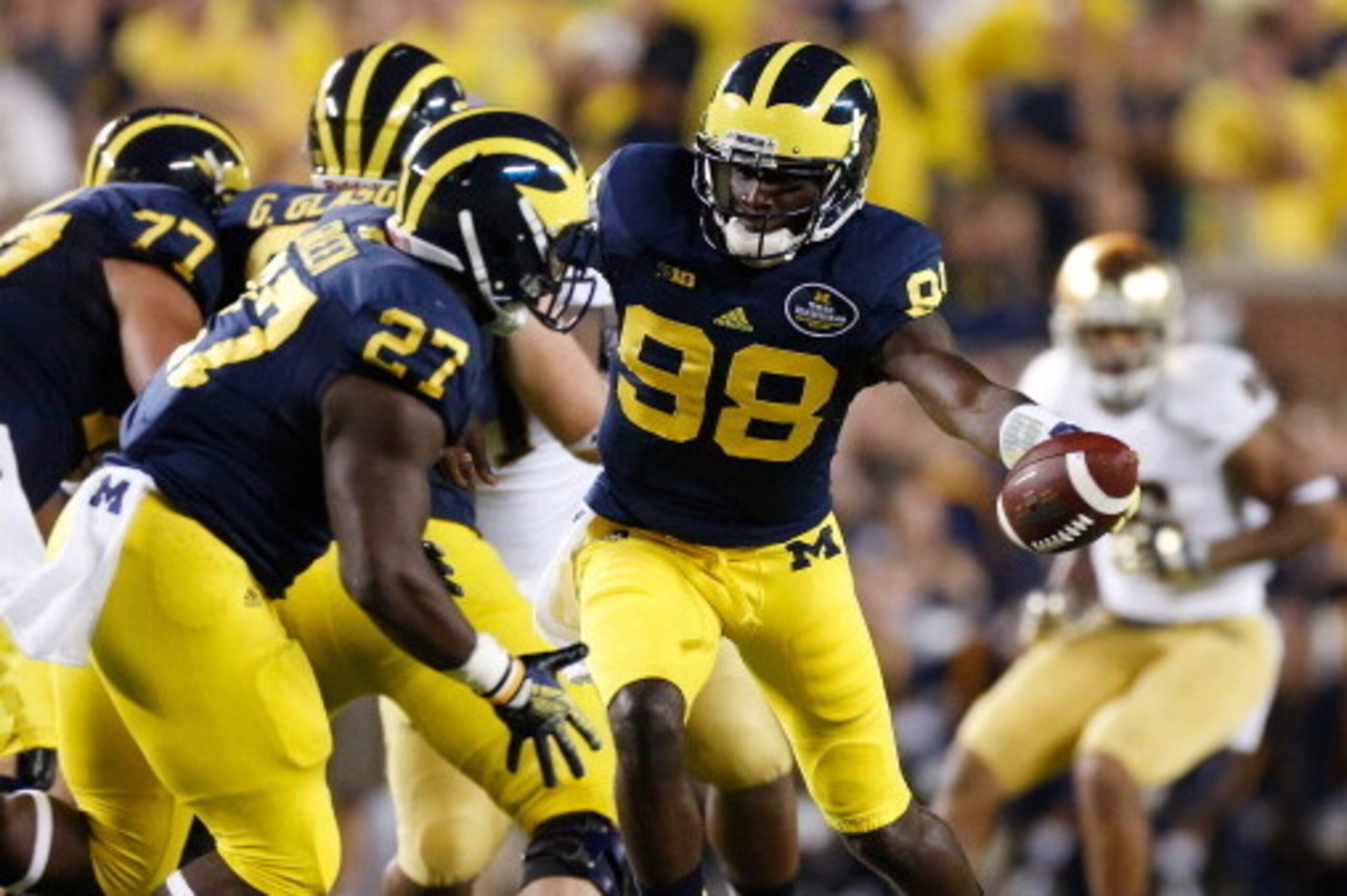 ANN ARBOR, MI - SEPTEMBER 07: Devin Gardner #98 of the Michigan Wolverines hands off to Derrick Green #27 against the Notre Dame Fighting Irish at Michigan Stadium on September 7, 2013 in Ann Arbor, Michigan. (Photo by Gregory Shamus/Getty Images)