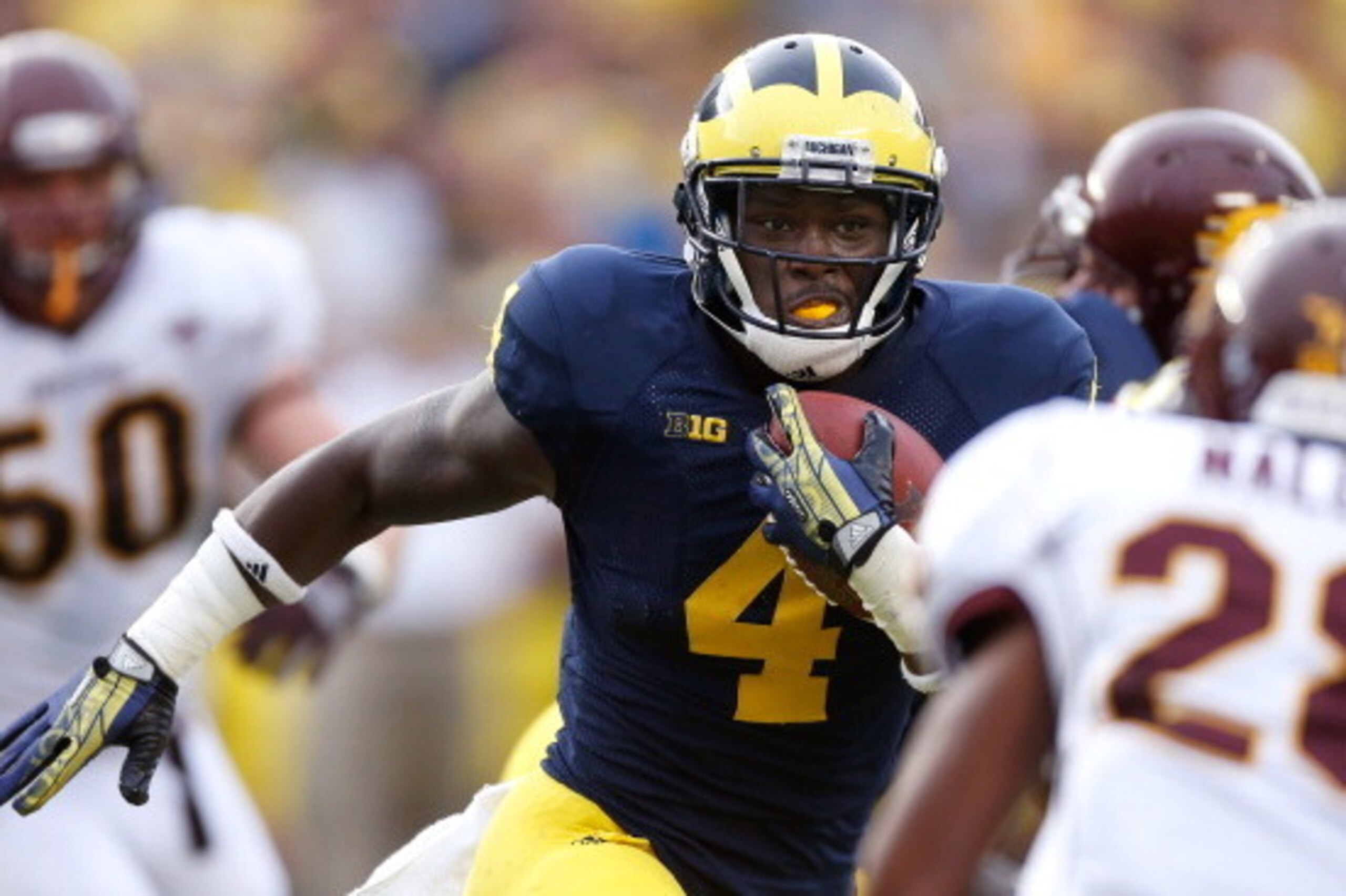 ANN ARBOR, MI - AUGUST 31: De'Veon Smith #4 of the Michigan Wolverines looks for extra yards during a fourth quarter run while playing the Central Michigan Chippewas at Michigan Stadium on August 31, 2013 in Ann Arbor, Michigan. Michigan won the 59-9. (Ph