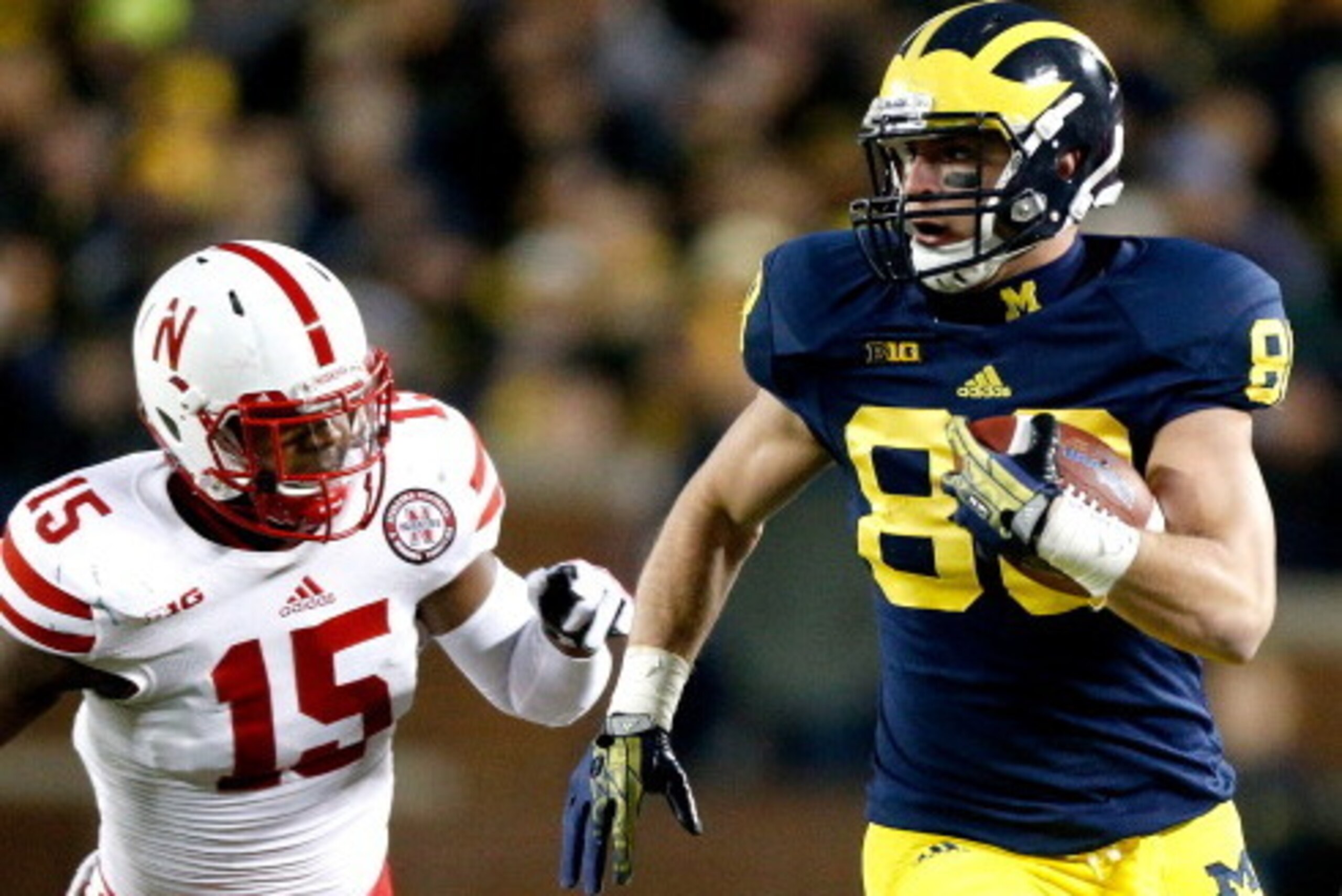 ANN ARBOR, MI - NOVEMBER 09:  Jake Butt #88 of the Michigan Wolverines heads down the sideline against Michael Rose #15 of the Nebraska Cornhuskers in the third quarter at Michigan Stadium on November 9, 2013 in Ann Arbor, Michigan.  (Photo by Gregory Sha