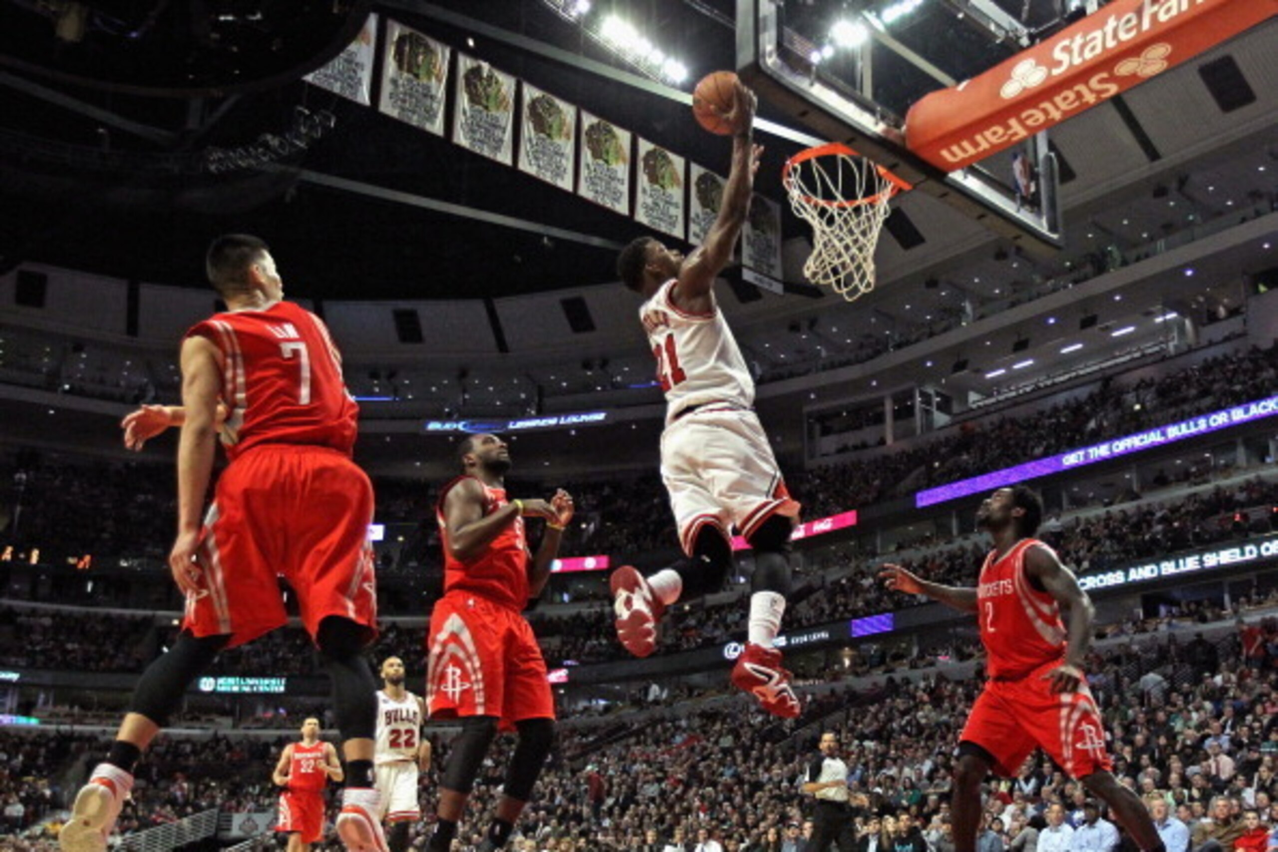 CHICAGO, IL - MARCH 13: Jimmy Butler #21 of the Chicago Bulls shoots between (L-R) Jeremy Lin #7, Jordan Hamilton #5 and Patrick Beverly #2 of the Houston Rockets at the United Center on March 13, 2014 in Chicago, Illinois. The Bulls defeated the Rockets 