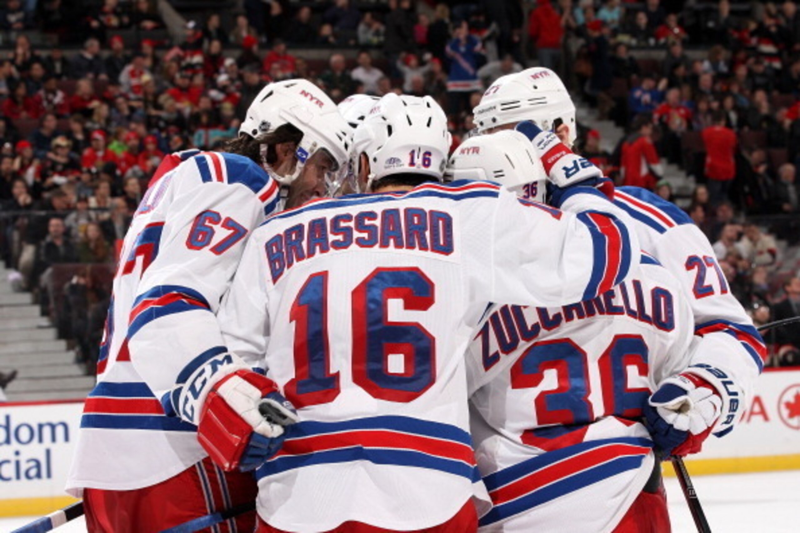 OTTAWA, ON - JANUARY 18: Mats Zuccarello #36 of the New York Rangers celebrates his third period goal with team mates Benoit Pouliot #67 and Derick Brassard #16 during an NHL game against the Ottawa Senators at Canadian Tire Centre on January 18, 2014 in 