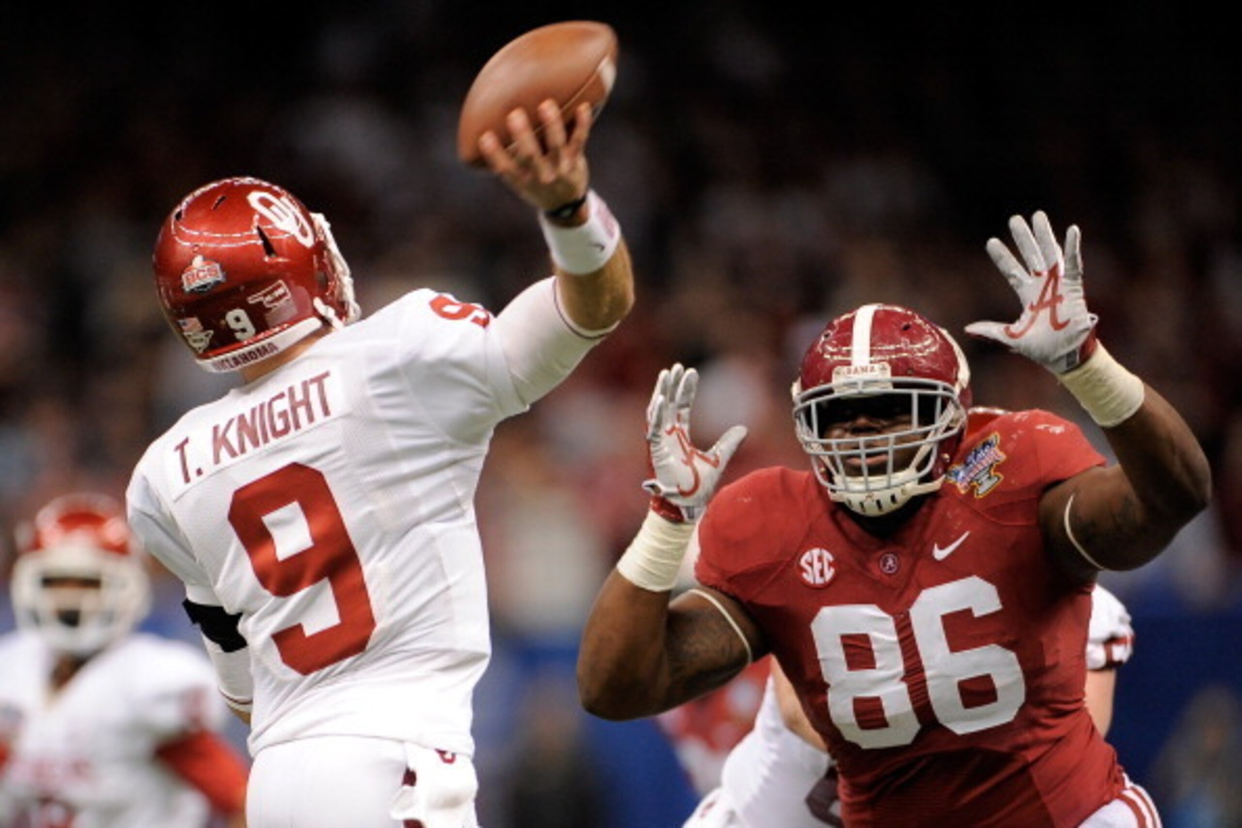 NEW ORLEANS, LA - JANUARY 02: Trevor Knight #9 of the Oklahoma Sooners is pressured by A'Shawn Robinson #86 of the Alabama Crimson Tide during the Allstate Sugar Bowl at the Mercedes-Benz Superdome on January 2, 2014 in New Orleans, Louisiana.  (Photo by 