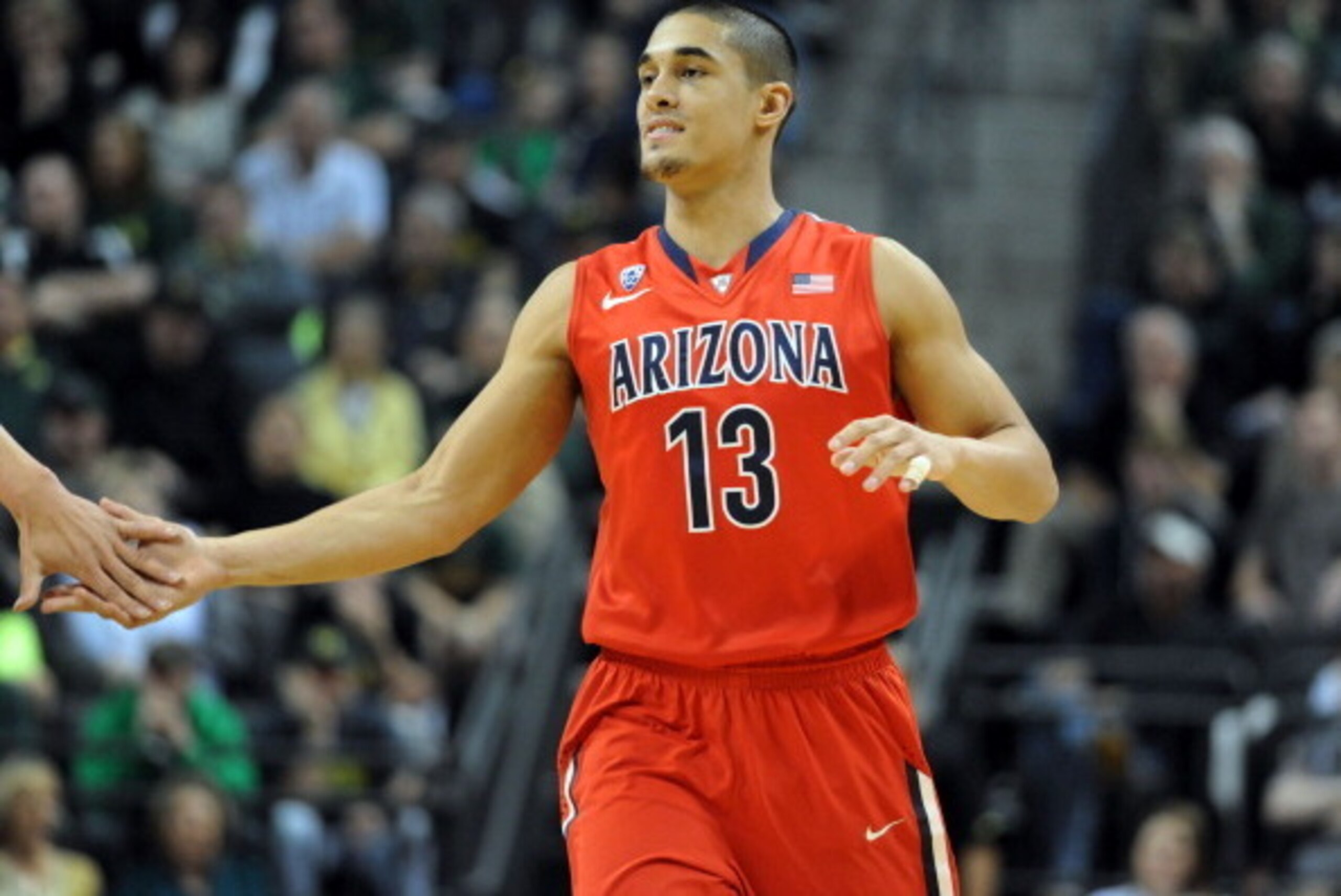 EUGENE, OR - MARCH 8:  Nick Johnson #13 of the Arizona Wildcats is greeted at the bench during the first half of the game against the Oregon Ducks at Matthew Knight Arena on March 8, 2014 in Eugene, Oregon.  (Photo by Steve Dykes/Getty Images)