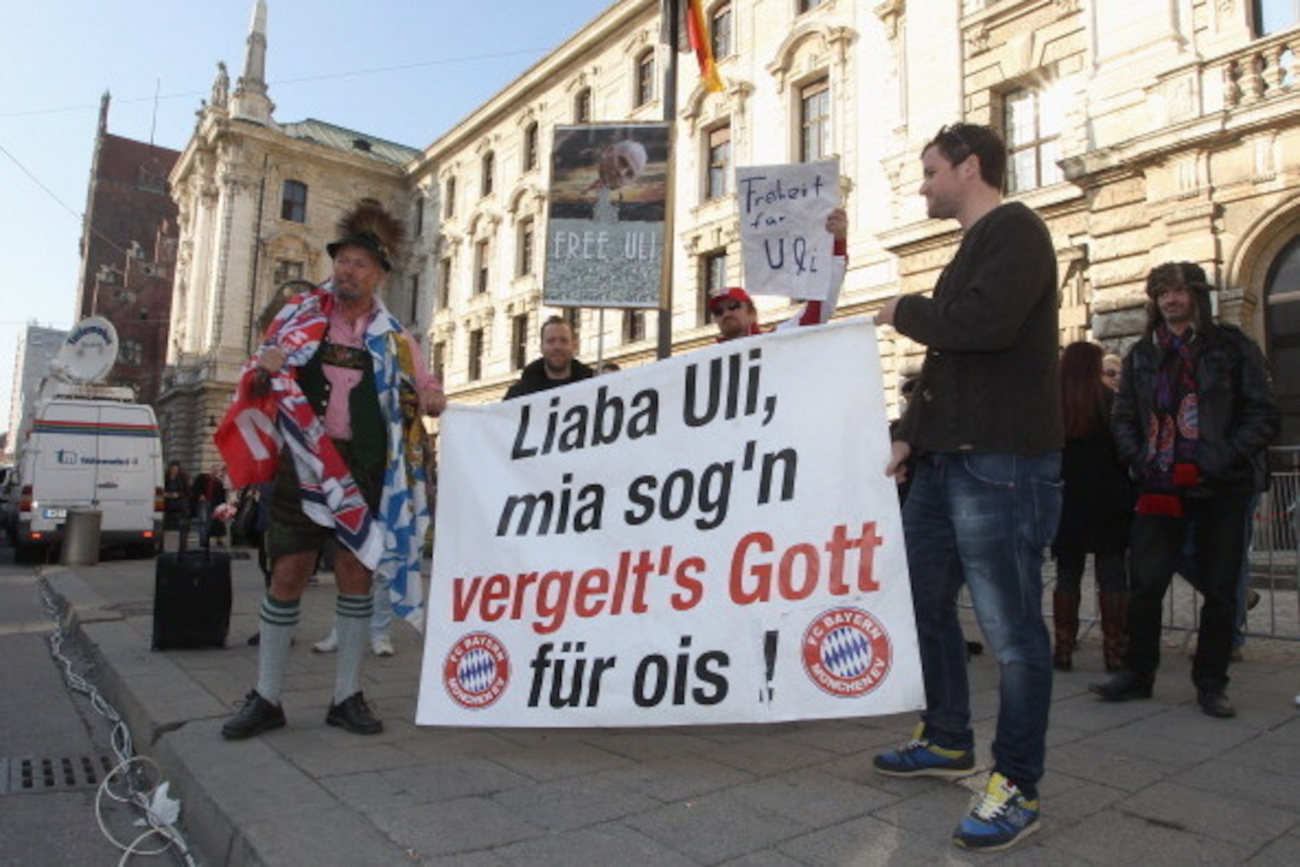 MUNICH, GERMANY - MARCH 13:  Bayern Muenchen fans hold up banners for president of Bayern Muenchen Ulrich Hoeness in front of the Higher Regional Court on March 13, 2014 in Munich, Germany. President of Bayern Muenchen Ulrich Hoeness is sentenced to three