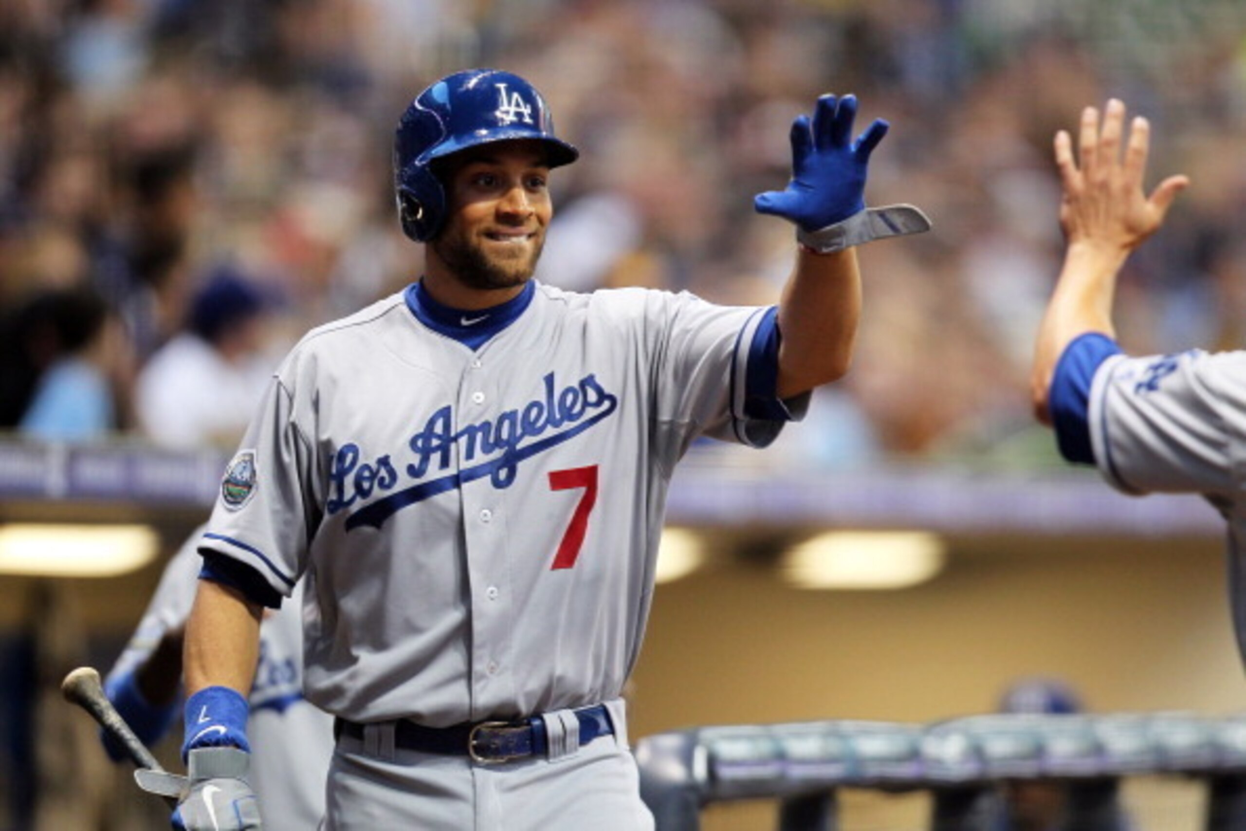 Milwaukee, WI - APRIL 18:   James Loney #7 of the Los Angeles Dodgers high fives Mark Ellis after scoring the Dodgers first run against the Milwaukee Brewers during the game at Miller Park on April 18, 2012 in Milwaukee, Wisconsin. (Photo by Mike McGinnis