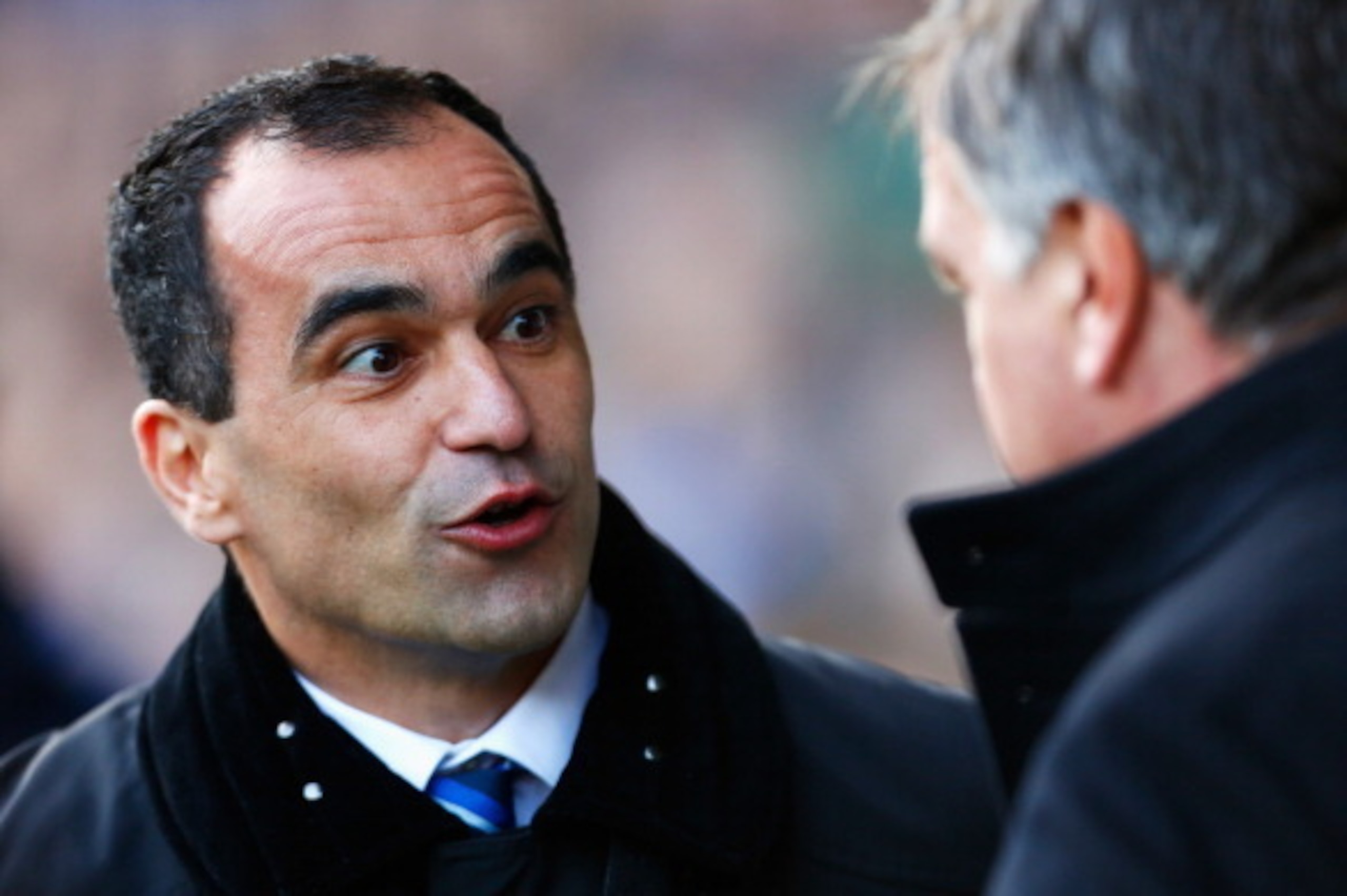 LIVERPOOL, ENGLAND - MARCH 01: Roberto Martinez (L), manager of Everton talks to Sam Allardyce, manager of West Ham United during the Barclays Premier League match between Everton and West Ham United at Goodison Park on March 1, 2014 in Liverpool, England