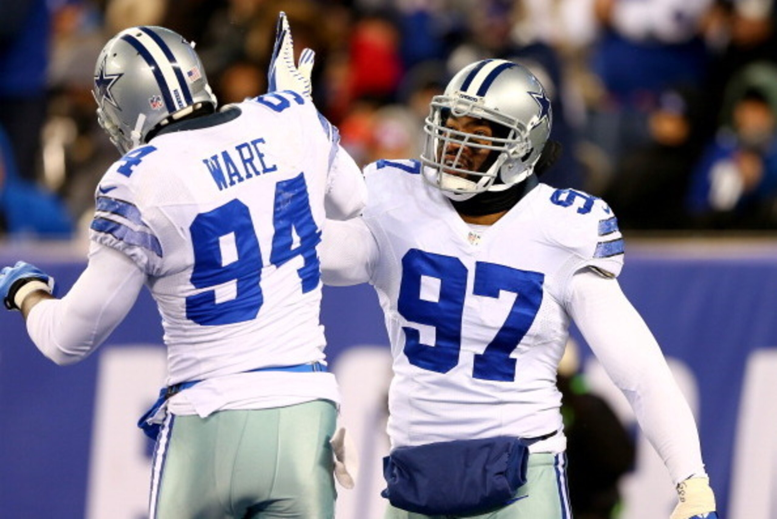 EAST RUTHERFORD, NJ - NOVEMBER 24:  Jason Hatcher #97 of the Dallas Cowboys celebrates with teammate DeMarcus Ware #94 after he sacked Eli Manning of the New York Giants at MetLife Stadium on November 24, 2013 in East Rutherford, New Jersey.  (Photo by El