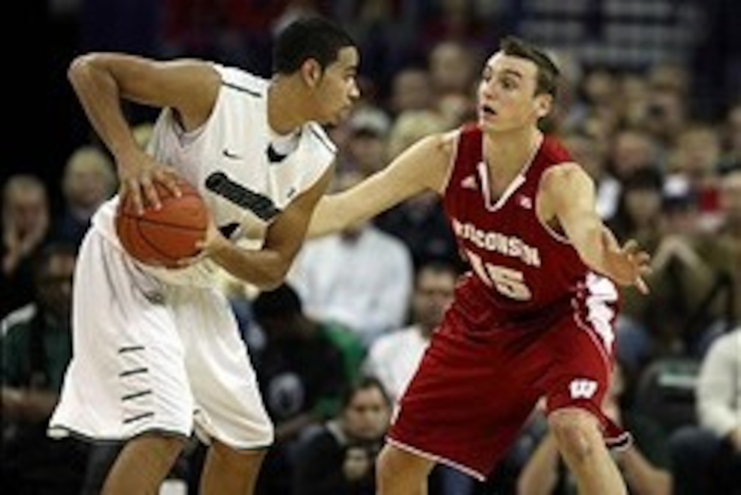 Nov 16, 2013; Green Bay, WI, USA; Wisconsin-Green Bay Phoenix guard Jordan Fouse (4) looks to pass as Wisconsin Badgers forward Sam Dekker (15) defends at the Resch Center in Ashwaubenon. The Wisconsin Badgers defeated Wisconsin-Green Bay 69-66.  Mandator