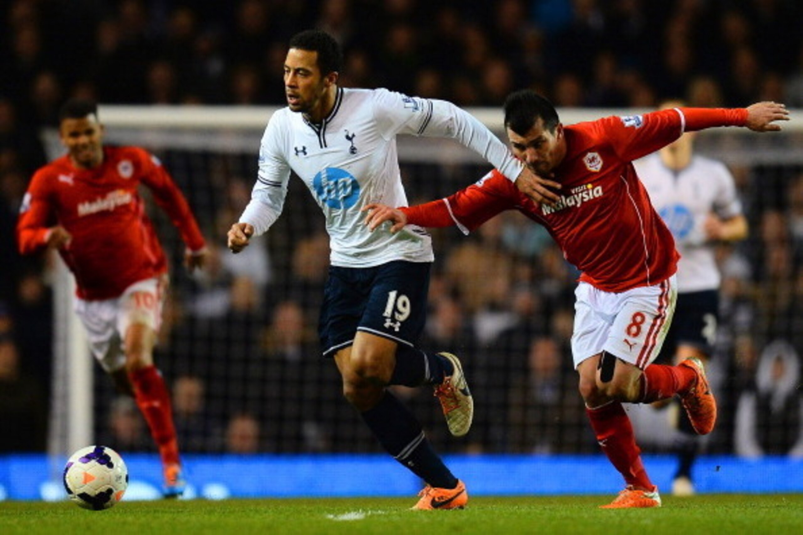 LONDON, ENGLAND - MARCH 02: Mousa Dembele of Tottenham Hotspur holds off pressure from Gary Medel of Cardiff City during the Barclays Premier League match between Tottenham Hotspur and Cardiff City at White Hart Lane on March 2, 2014 in London, England.  