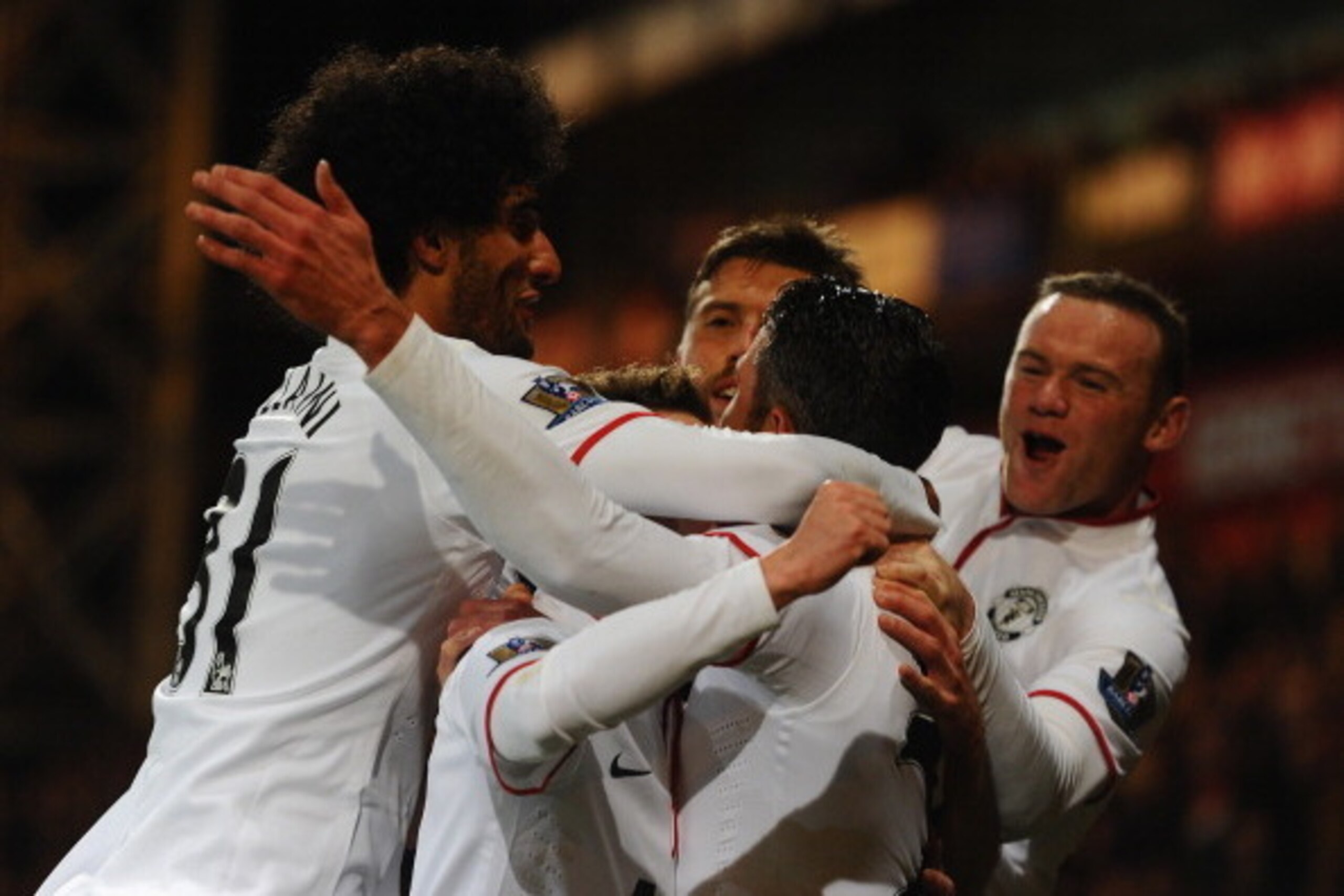 LONDON, ENGLAND - FEBRUARY 22:  Robin Van Persie of Man United is mobbed by team mates after scoring from the spot during the Barclays Premier League match between Crystal Palace and Manchester United at Selhurst Park on February 22, 2014 in London, Engla