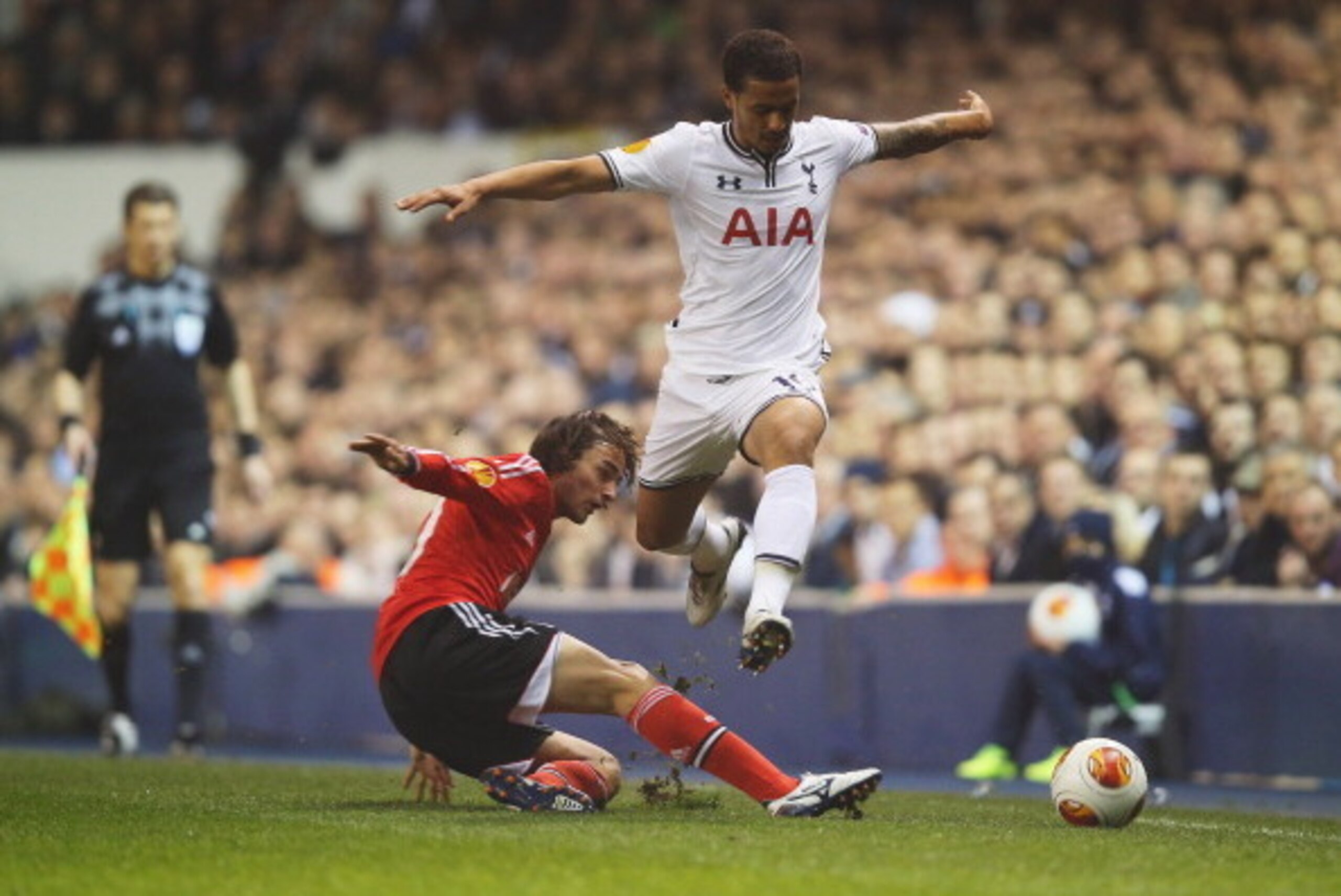 LONDON, ENGLAND - MARCH 13:  Kyle Naughton of Tottenham Hotspur is tackled by Lazar Markovic of Benfica during the UEFA Europa League Round of 16 first leg match between Tottenham Hotspur FC and SL Benfica at White Hart Lane on March 13, 2014 in London, E