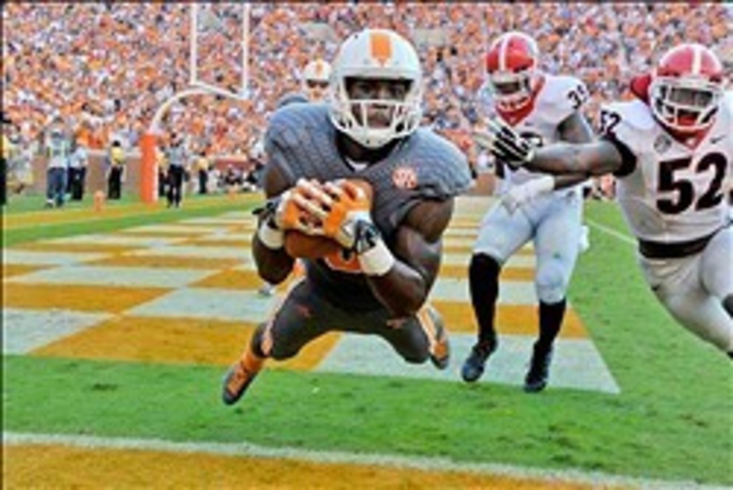 Oct 5, 2013; Knoxville, TN, USA; Tennessee Volunteers wide receiver Marquez North (8) catches a pass against Georgia Bulldogs linebacker Amarlo Herrera (52) for a touchdown during the second half at Neyland Stadium. Mandatory Credit: Jim Brown-USA TODAY S