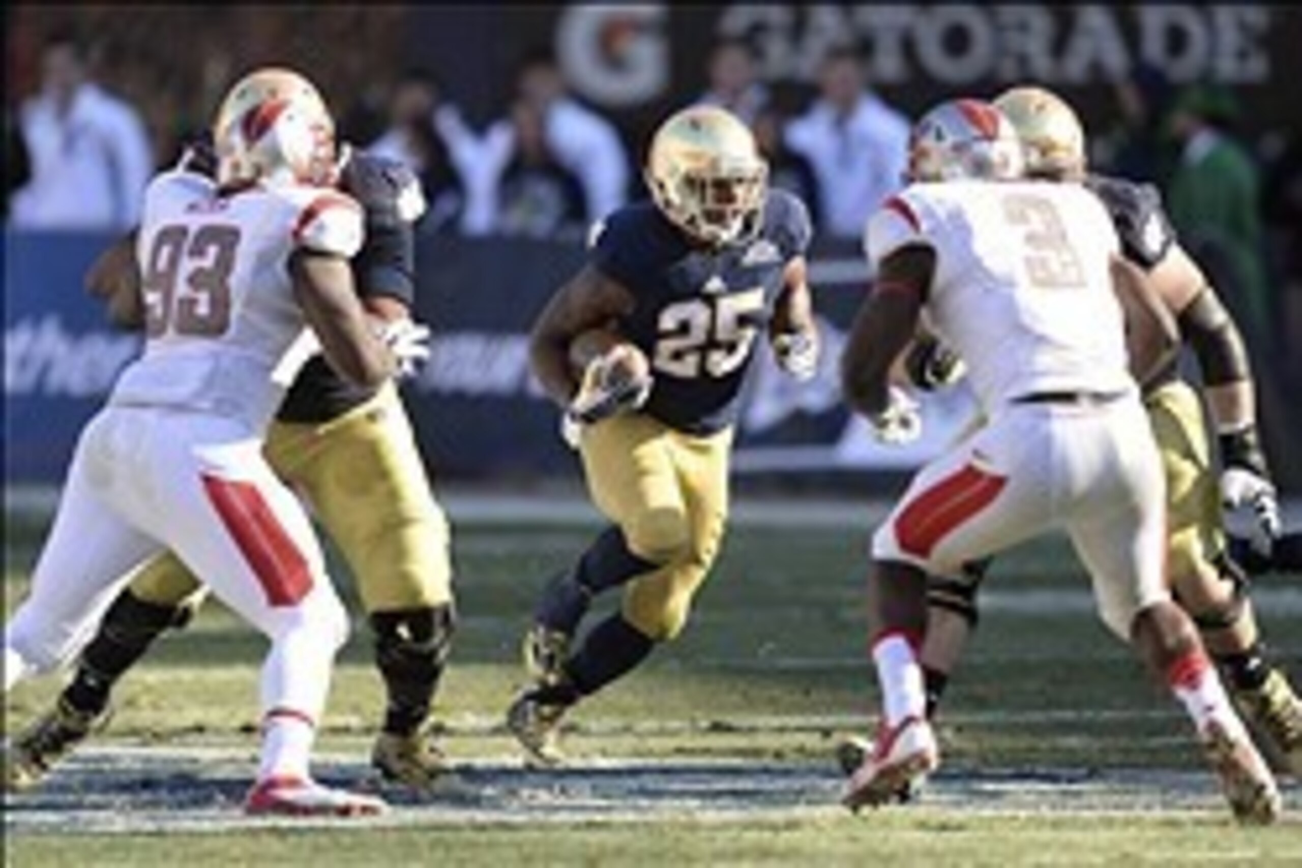 Dec 28, 2013; Bronx, NY, USA; Notre Dame Fighting Irish running back Tarean Folston (25) runs the ball against the Rutgers Scarlet Knights during the first half of the Pinstripe Bowl at Yankees Stadium. Notre Dame Fighting Irish won the game 29-16. Mandat