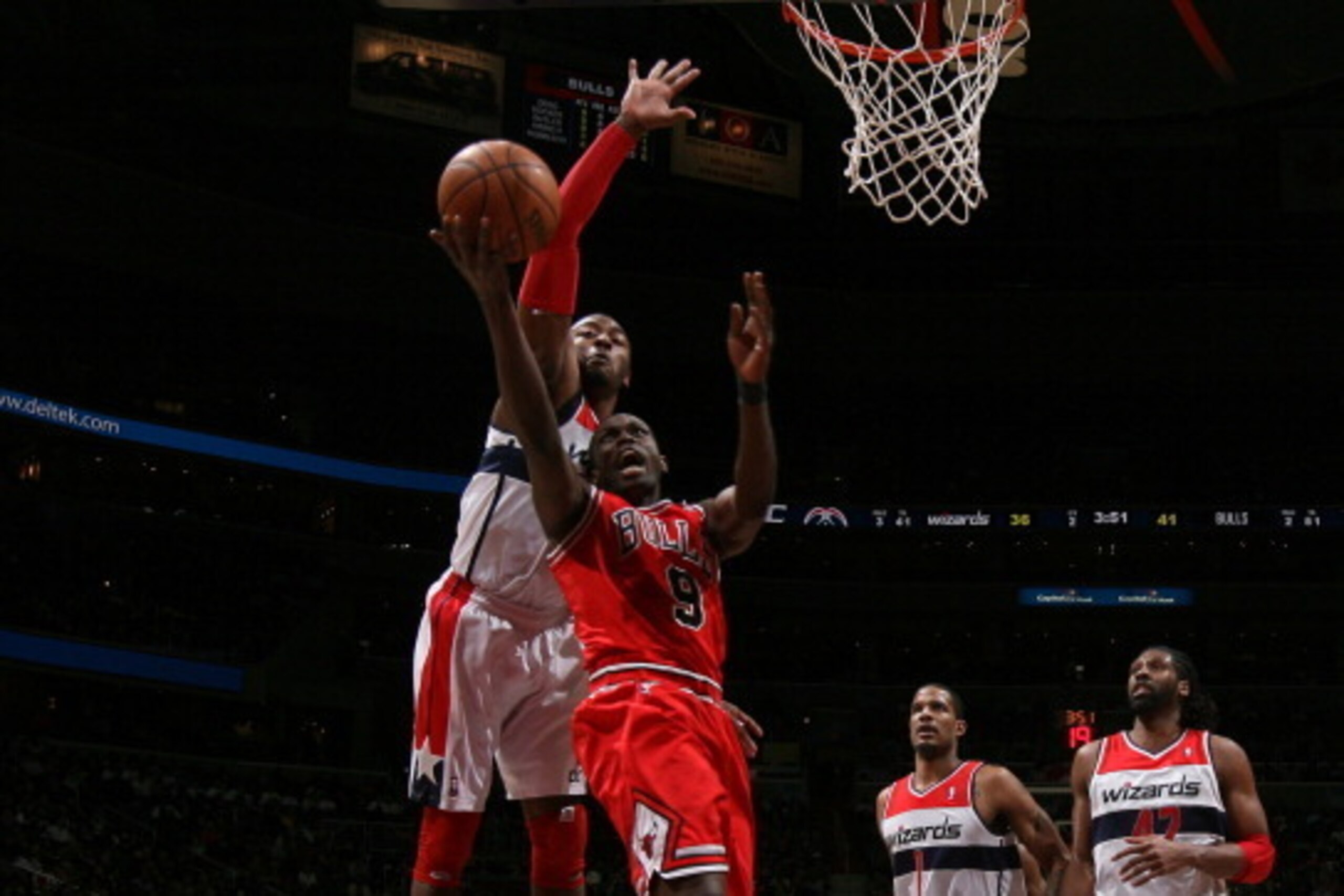 WASHINGTON, DC - APRIL 2: John Wall #2 of the Washington Wizards blocks a shot against Luol Deng #9 of the Chicago Bulls during the game at the Verizon Center on April 2, 2013 in Washington, DC. NOTE TO USER: User expressly acknowledges and agrees that, b