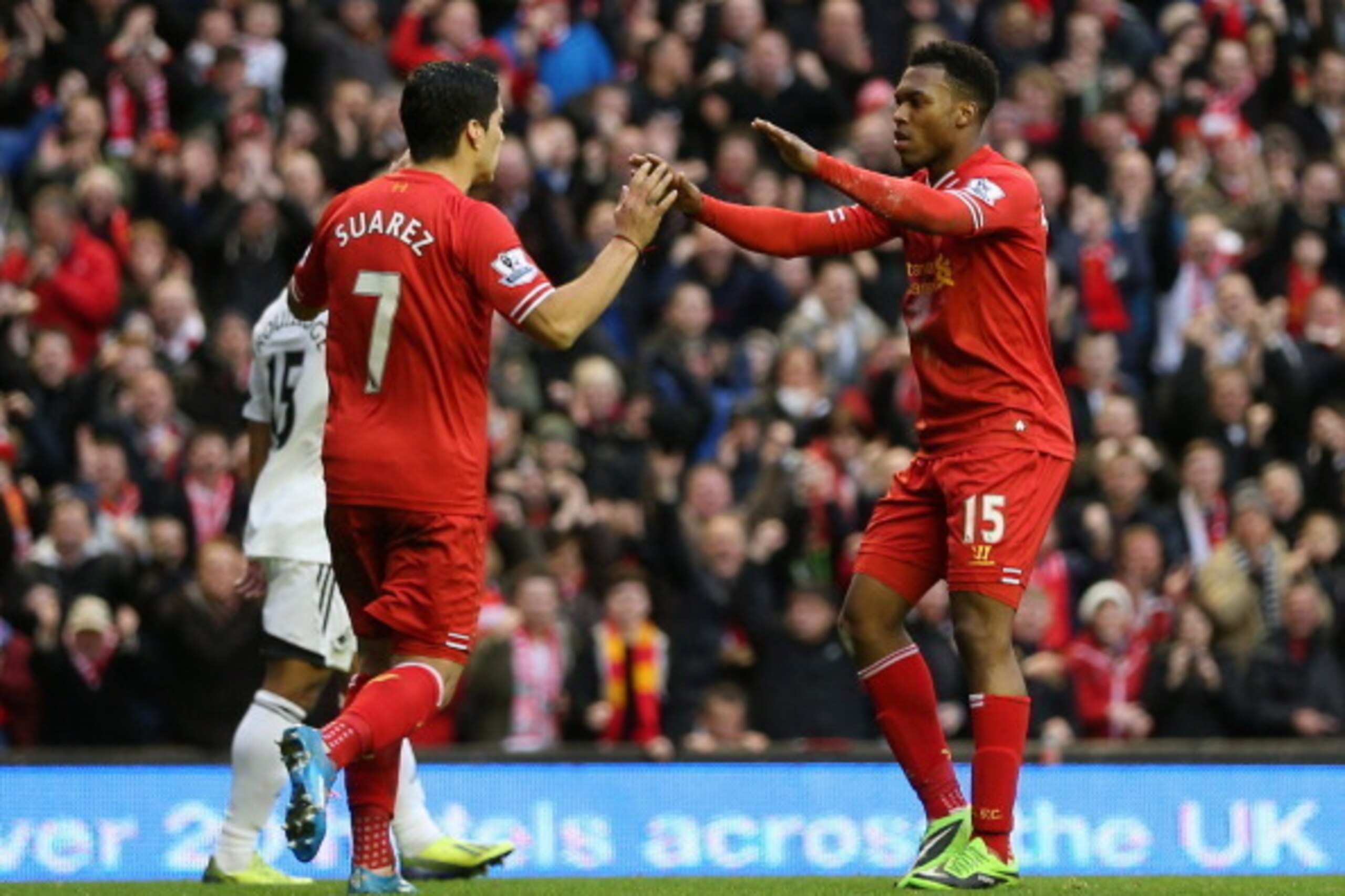 LIVERPOOL, ENGLAND - FEBRUARY 23:  Daniel Sturridge of Liverpool celebrates scoring his team's third goal with Luis Suarez during the Barclays Premier League match between Liverpool and Swansea City at Anfield on February 23, 2014 in Liverpool, England.  