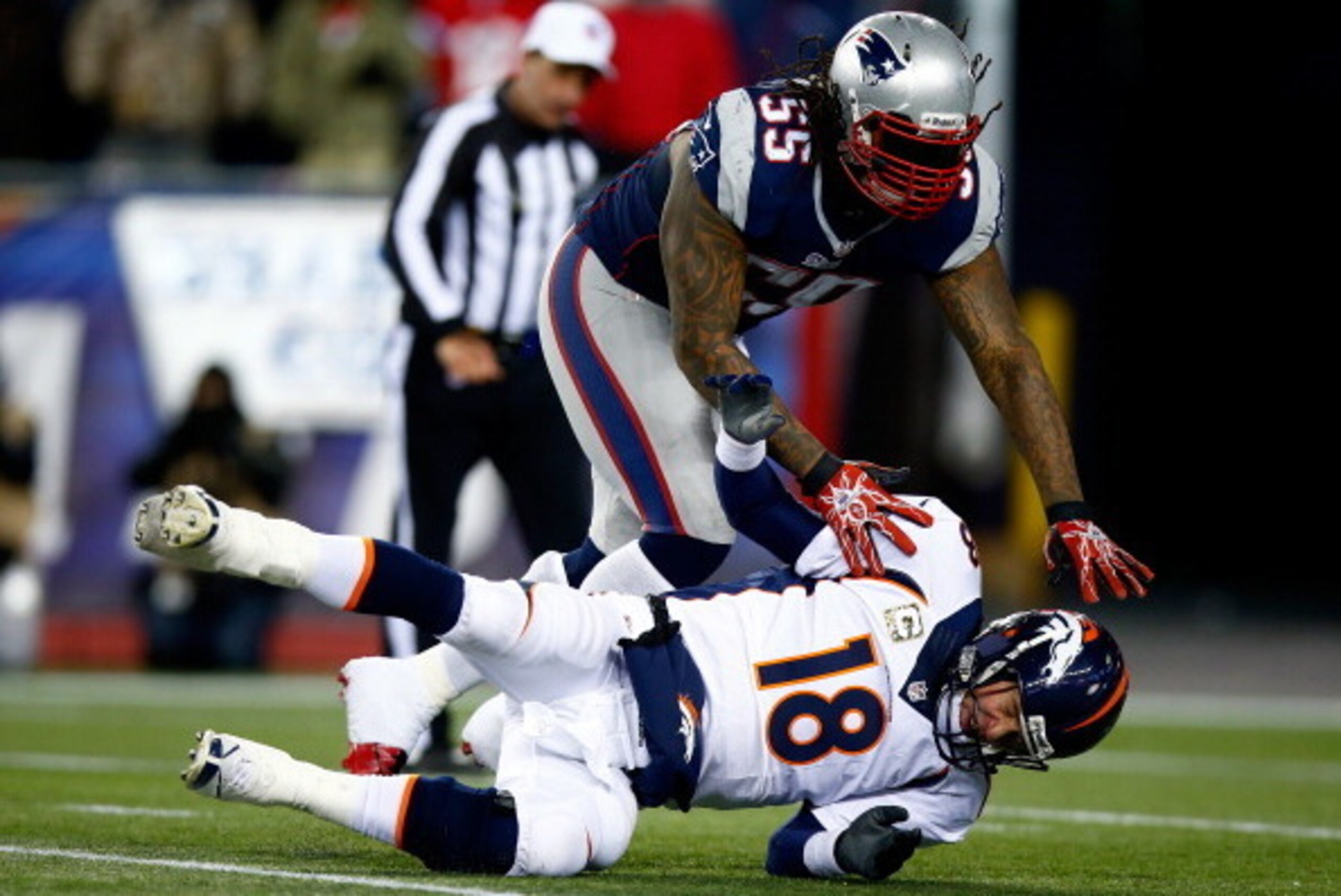 FOXBORO, MA - NOVEMBER 24: Middle linebacker Brandon Spikes #55 of the New England Patriots  tackles quarterback Peyton Manning #18 of the Denver Broncos during a game at Gillette Stadium on November 24, 2013 in Foxboro, Massachusetts.  (Photo by Jared Wi