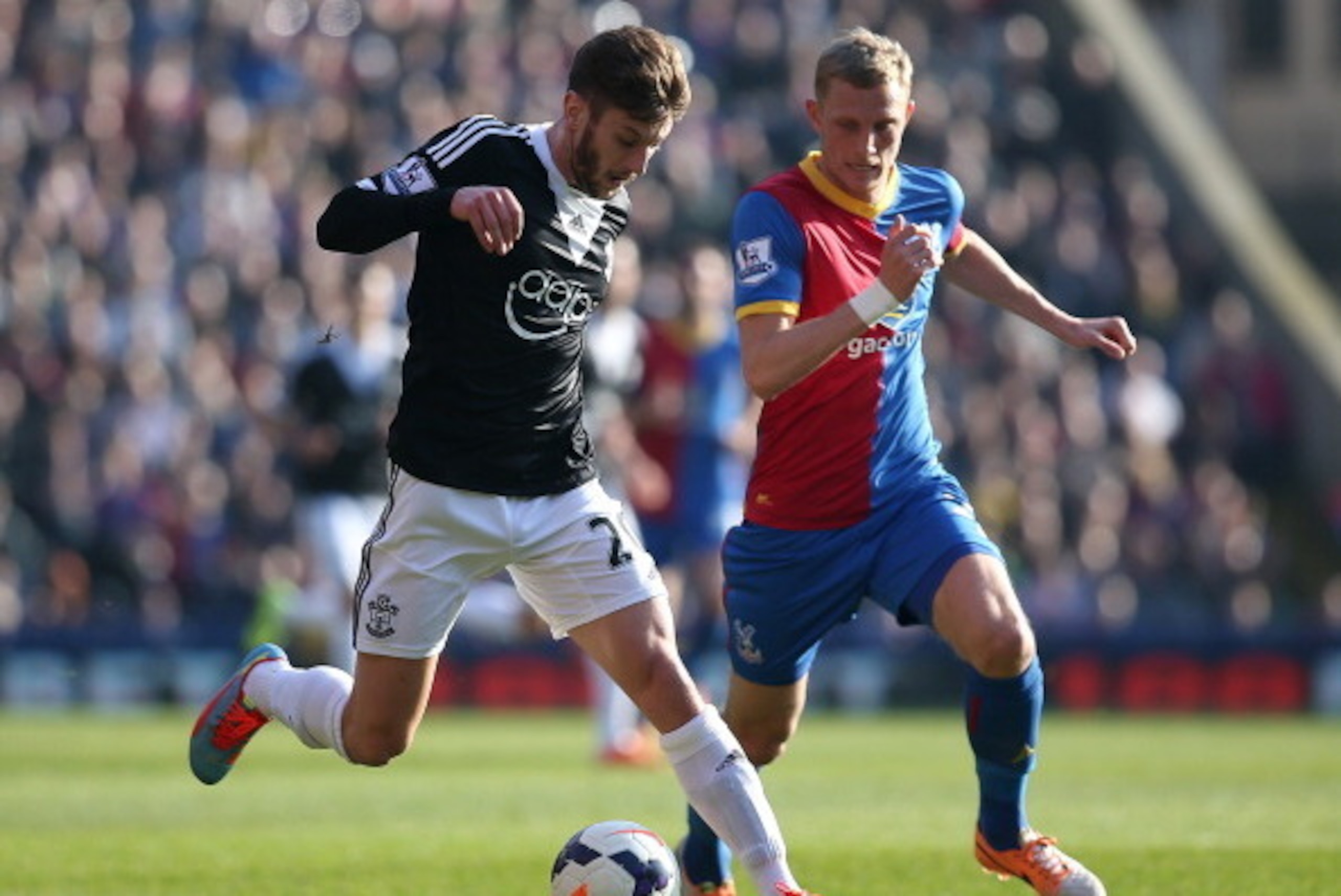 LONDON, ENGLAND - MARCH 08: Adam Lallana of Southampton looks to get away from Palace's Dean Moxey during the Barclays Premier League match between Crystal Palace and Southampton at Selhurst Park on March 08, 2014 in London, England. (Photo by Charlie Cro