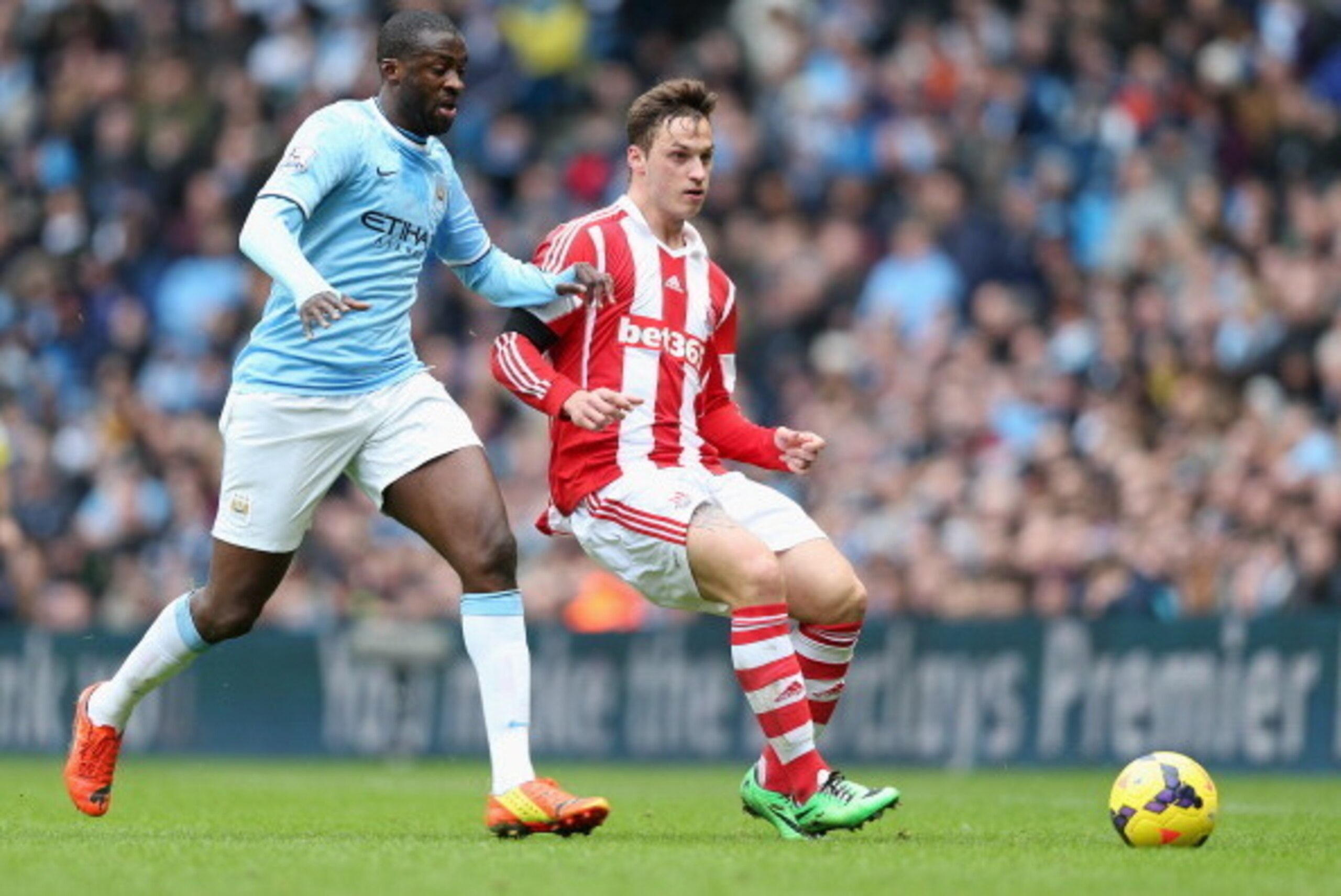 MANCHESTER, ENGLAND - FEBRUARY 22: Marko Arnautovic of Stoke City in action with Yaya Toure of Manchester City during the Barclays Premier League match between Manchester City and Stoke City at the Etihad Stadium on February 22, 2014 in Manchester, Englan