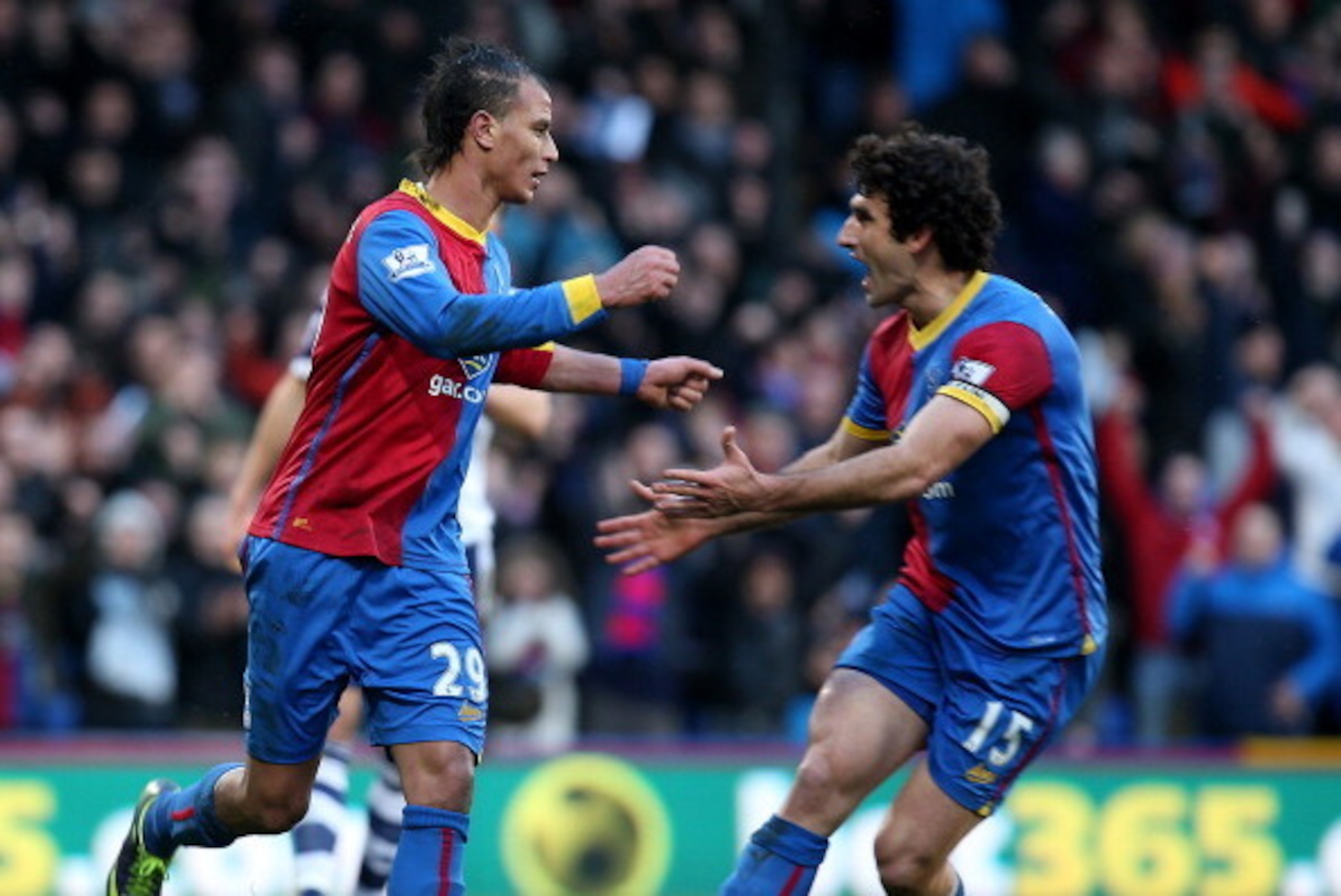 LONDON, ENGLAND - FEBUARY 08: Marouane Chamakh (L) of Palace celebrates with Mile Jidnak after scoring their third goal of the game with team mate Mile Jedinak during the Barclays Premier League match between Crystal Palace and West Bromwich Albion at Sel