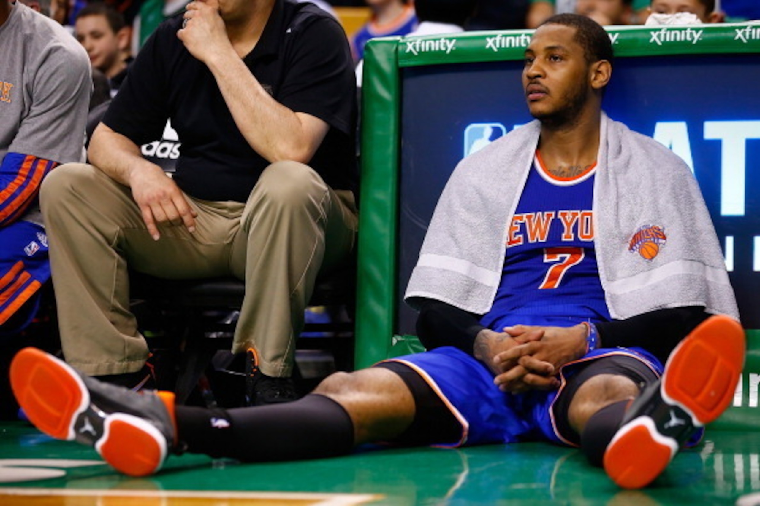 BOSTON, MA - MARCH 12: Carmelo Anthony #7 of the New York Knicks sits on the floor near the bench near the end of the game against the Boston Celtics during the game at TD Garden on March 12, 2014 in Boston, Massachusetts. NOTE TO USER: User expressly ack