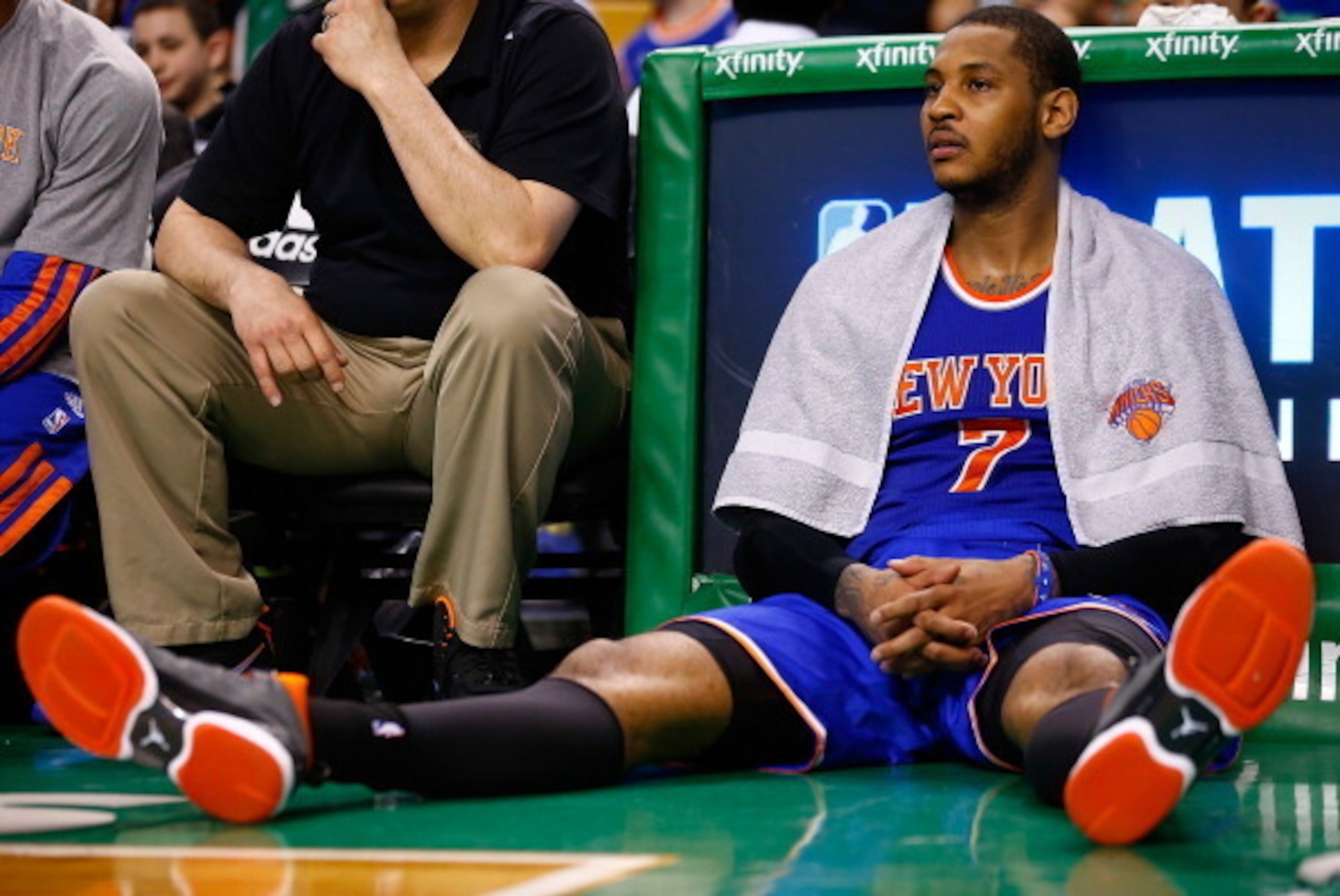 BOSTON, MA - MARCH 12: Carmelo Anthony #7 of the New York Knicks sits on the floor near the bench near the end of the game against the Boston Celtics during the game at TD Garden on March 12, 2014 in Boston, Massachusetts. NOTE TO USER: User expressly ack