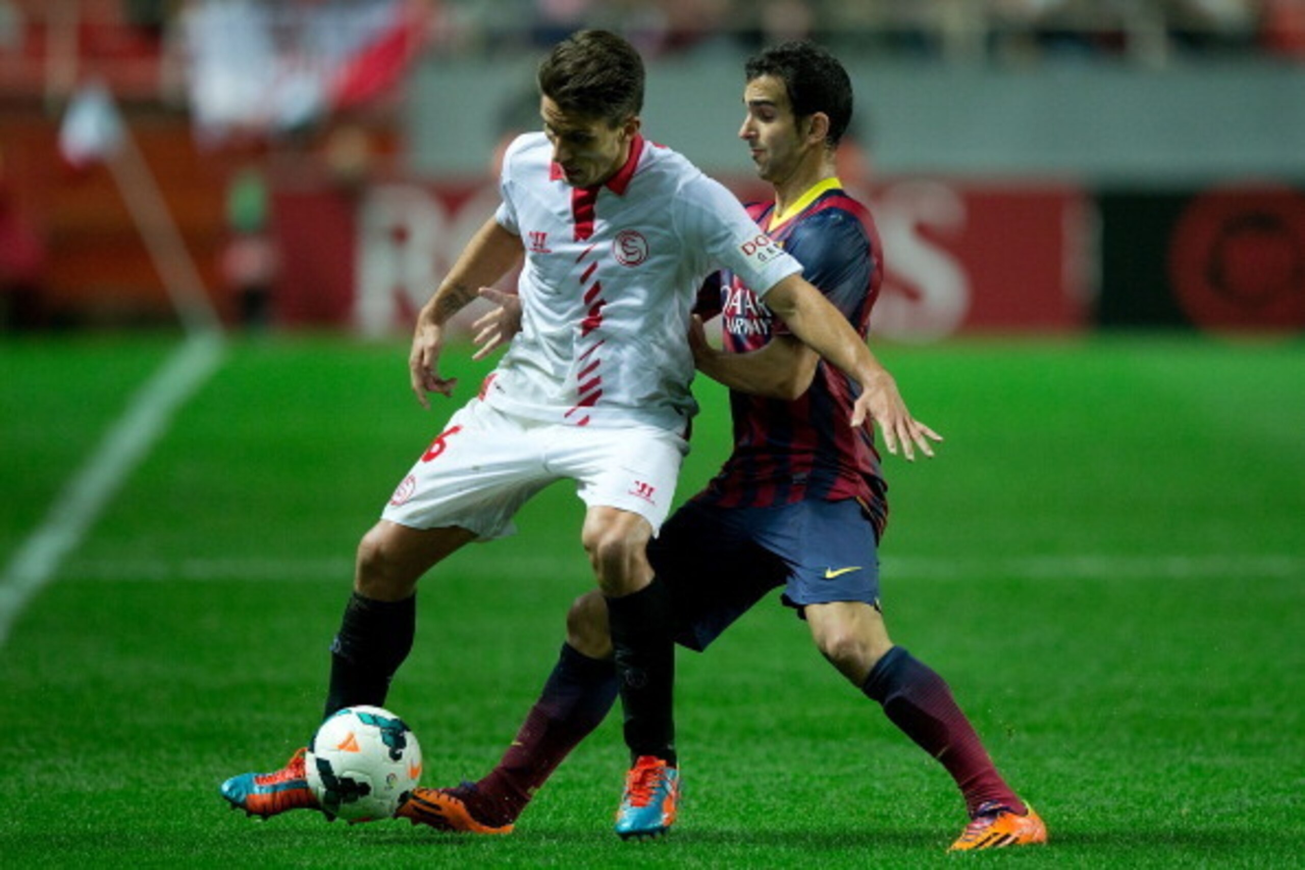 SEVILLE, SPAIN - FEBRUARY 09: Martin Montoya (R) of FC Barcelona competes for the ball with Daniel Carrico (L) of Sevilla FC during the La Liga match between Sevilla FC and FC Barcelona at Estadio Ramon Sanchez Pizjuan on February 9, 2014 in Seville, Spai SEVILLE, SPAIN - FEBRUARY 09: Martin Montoya (R) of FC Barcelona competes for the ball with Daniel Carrico (L) of Sevilla FC during the La Liga match between Sevilla FC and FC Barcelona at Estadio Ramon Sanchez Pizjuan on February 9, 2014 in Seville, Spai