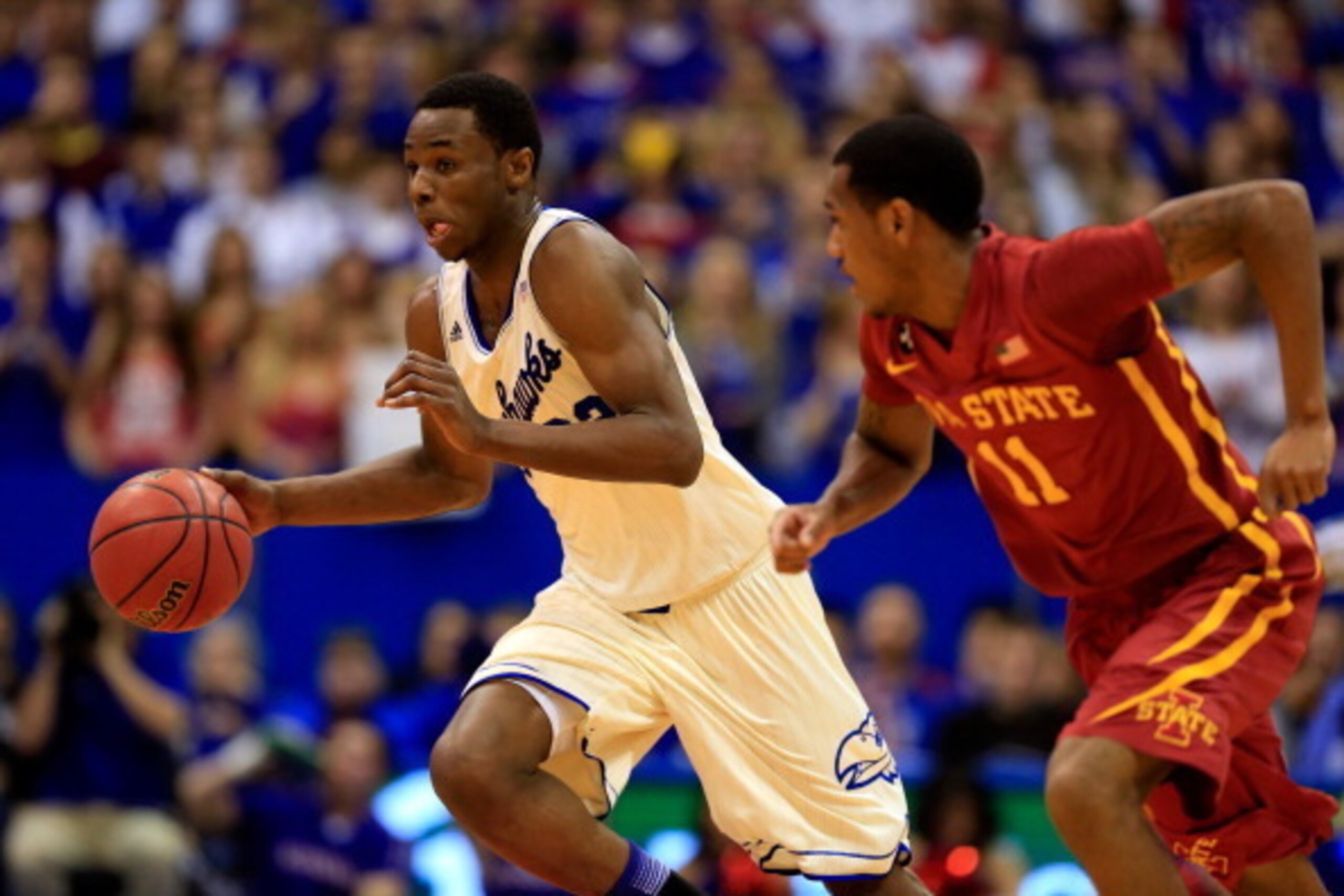 LAWRENCE, KS - JANUARY 29:  Andrew Wiggins #22 of the Kansas Jayhawks controls the ball as Monte Morris #11 of the Iowa State Cyclones defends during the game at Allen Fieldhouse on January 29, 2014 in Lawrence, Kansas.  (Photo by Jamie Squire/Getty Image