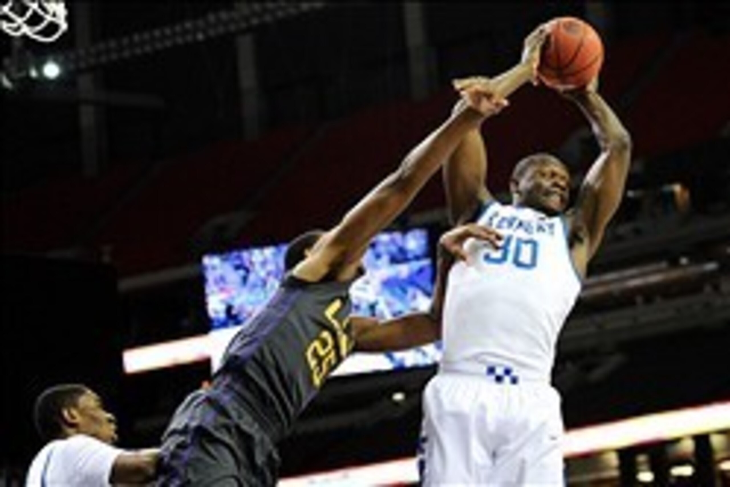 Mar 14, 2014; Atlanta, GA, USA; Kentucky Wildcats forward Julius Randle (30) grabs a rebound over LSU Tigers forward Jordan Mickey (25) during the first half in the quarterfinals of the SEC college basketball tournament at Georgia Dome.  Mandatory Credit: