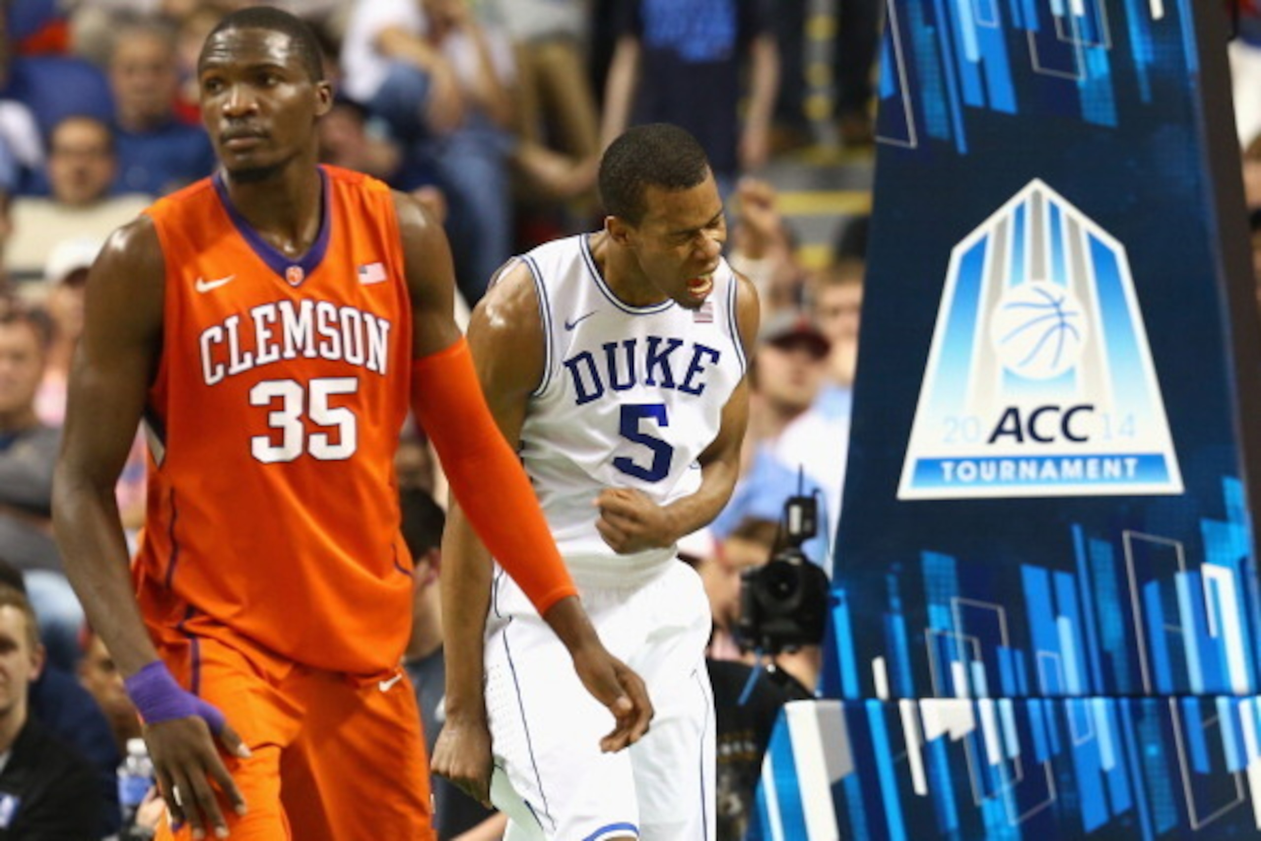 GREENSBORO, NC - MARCH 14:  Landry Nnoko #35 of the Clemson Tigers watches as Rodney Hood #5 of the Duke Blue Devils reacts after a play during the quarterfinals of the 2014 Men's ACC Basketball Tournament at Greensboro Coliseum on March 14, 2014 in Green