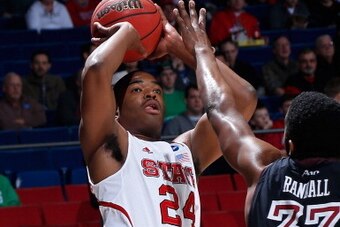 DAYTON, OH - MARCH 22: T.J. Warren #24 of the North Carolina State Wolfpack looks to shoot over Scootie Randall #33 of the Temple Owls in the first half during the second round of the 2013 NCAA Men's Basketball Tournament at UD Arena on March 22, 2013 in 
