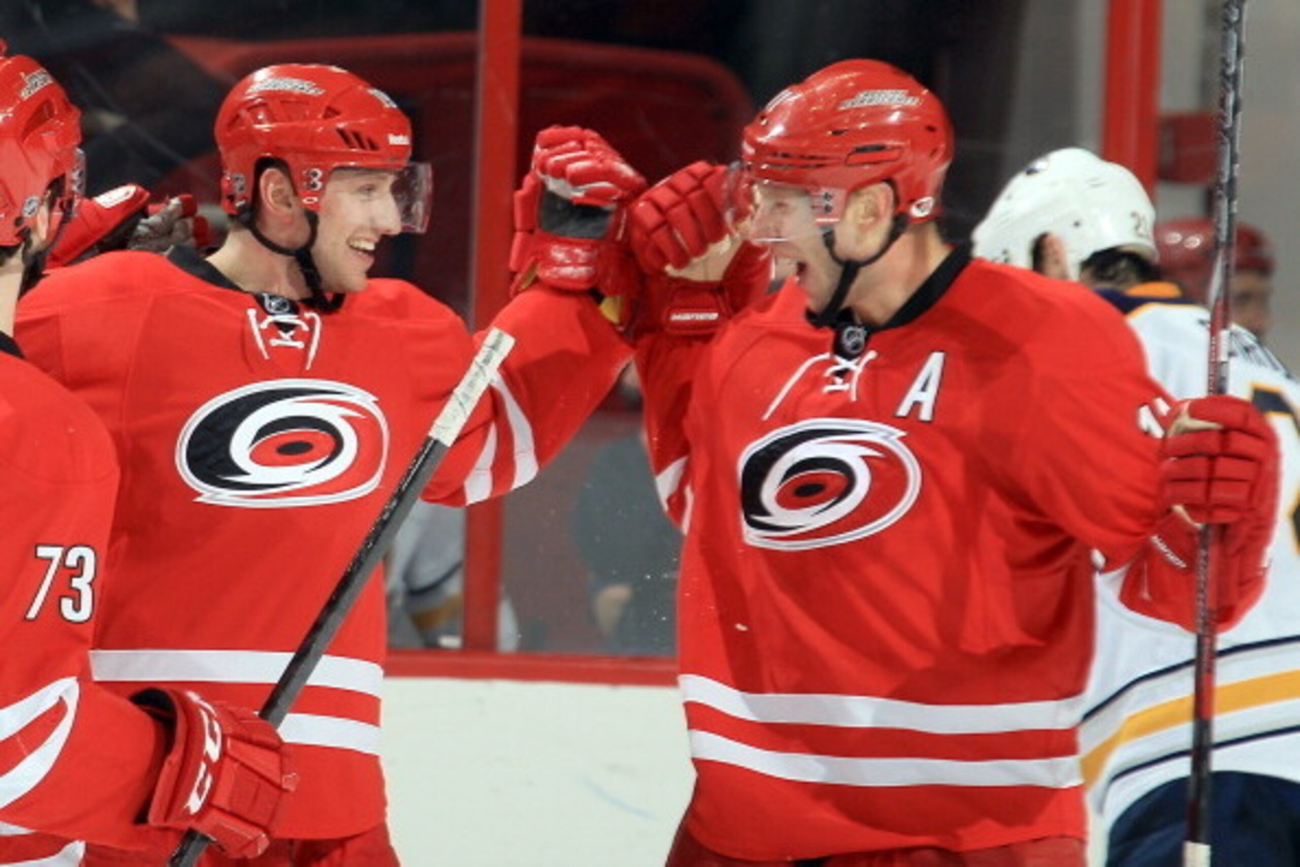 RALEIGH, NC - MARCH 13: Jiri Tlusty #19 of the Carolina Hurricanes celebrates his third-period goal against the Buffalo Sabres with teammate Jordan Staal #11 during their NHL game at PNC Arena on March 13, 2014 in Raleigh, North Carolina.  (Photo by Gregg
